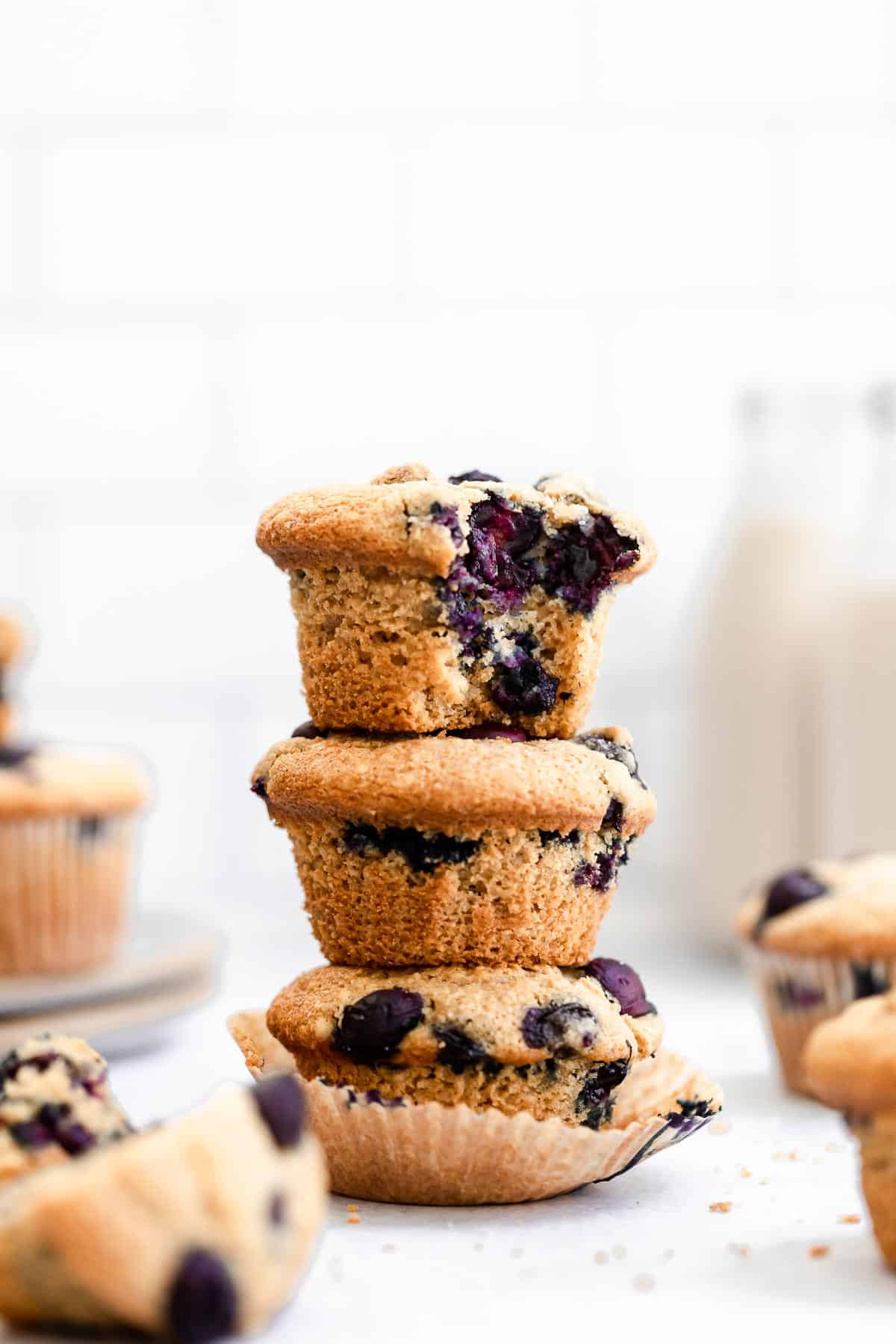 three gluten free blueberry muffins stacked on each other