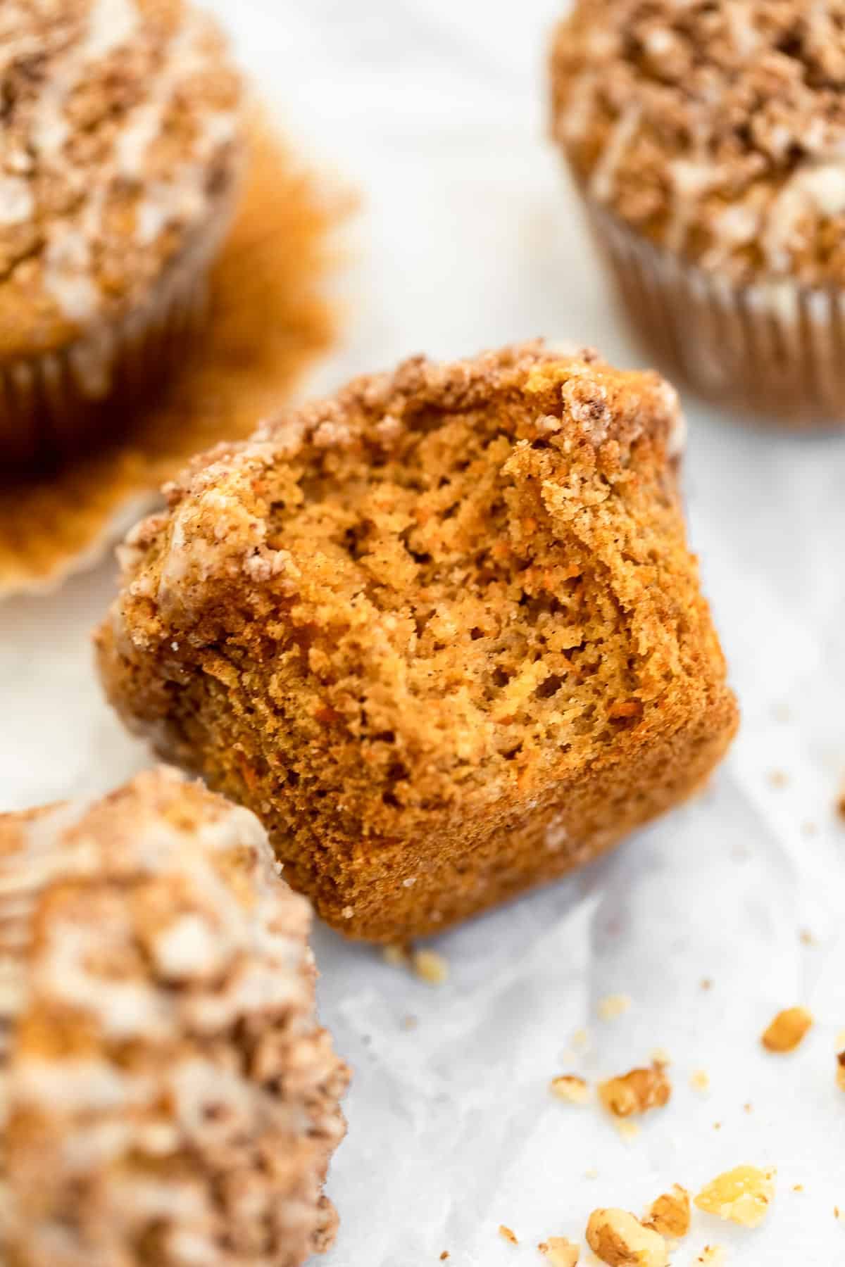one carrot cake muffin with a bite taken out