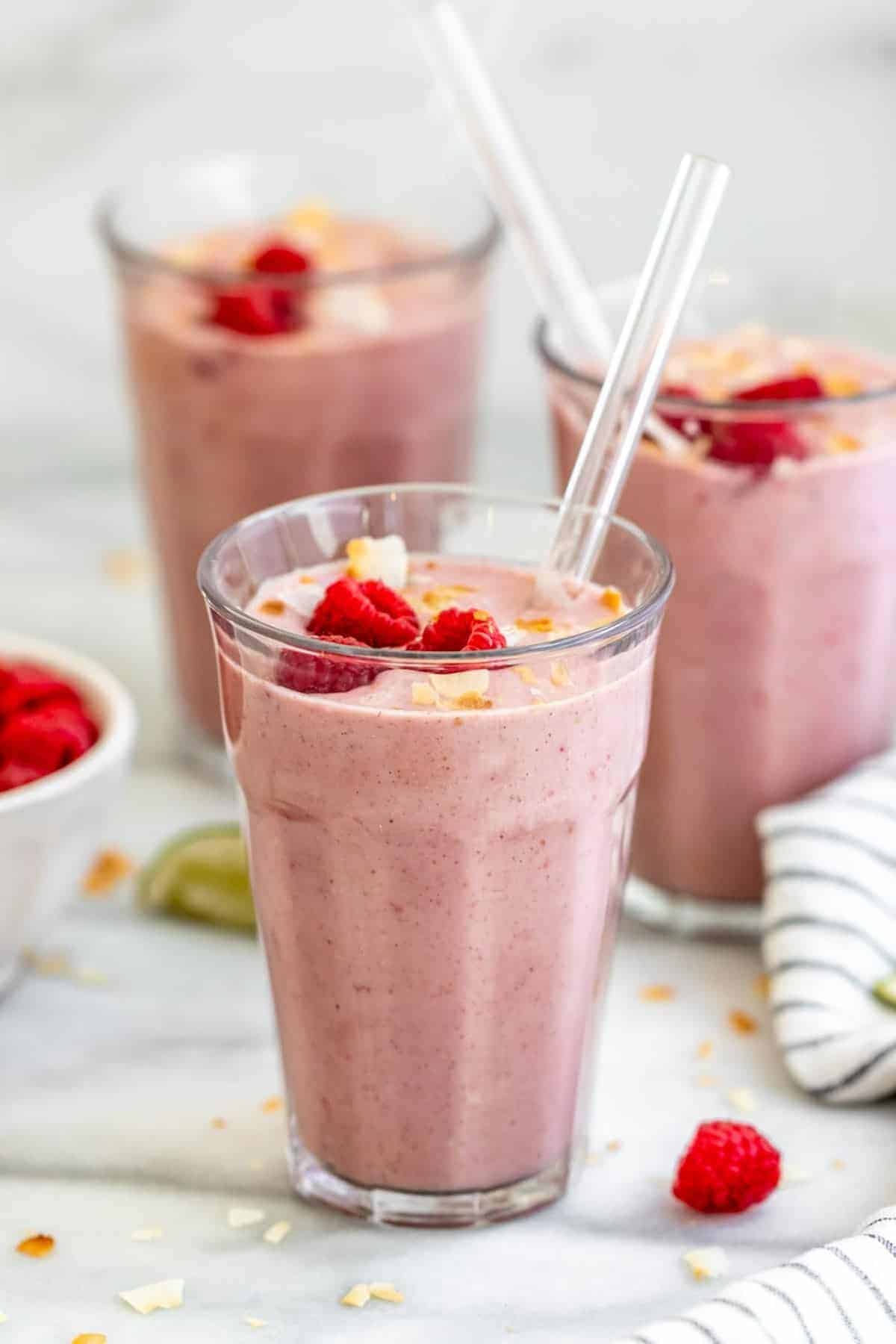Three Raspberry mango smoothies in glass cups.