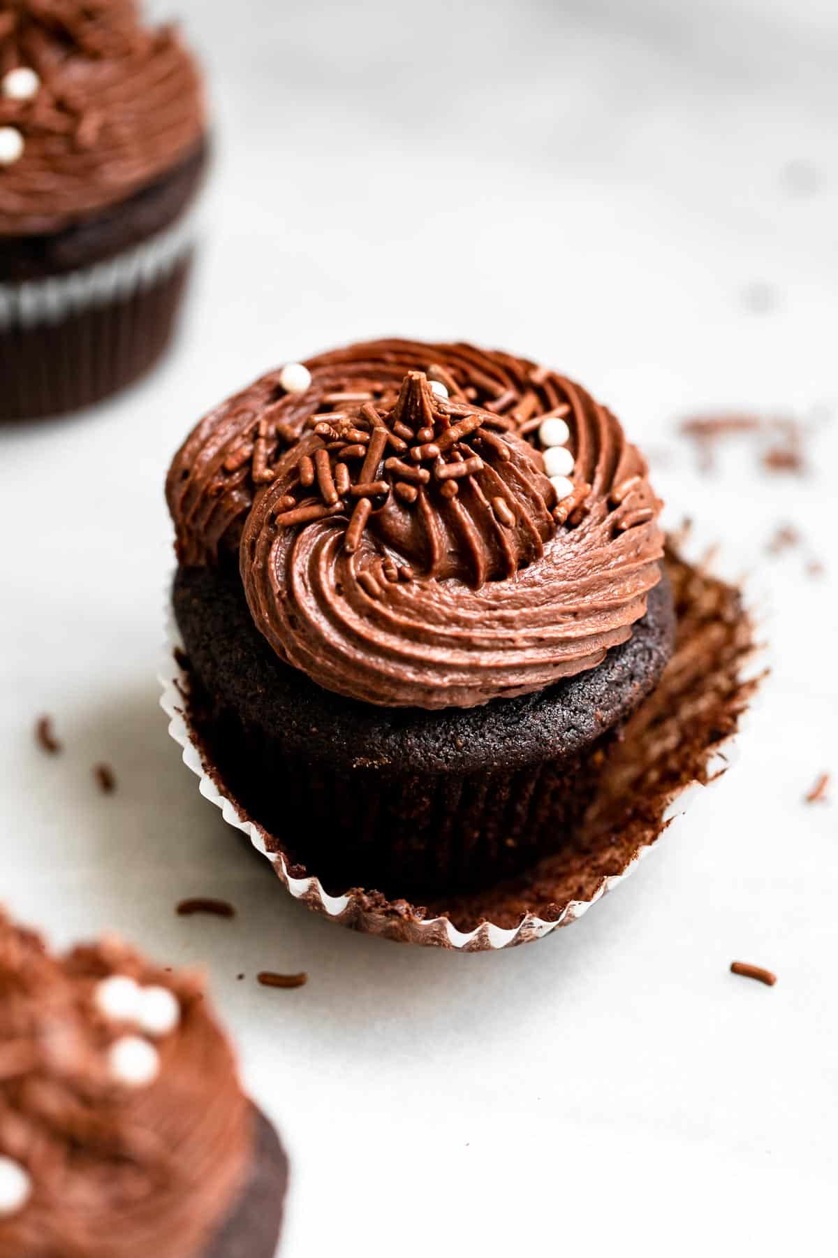 three vegan chocolate cupcakes with sprinkles