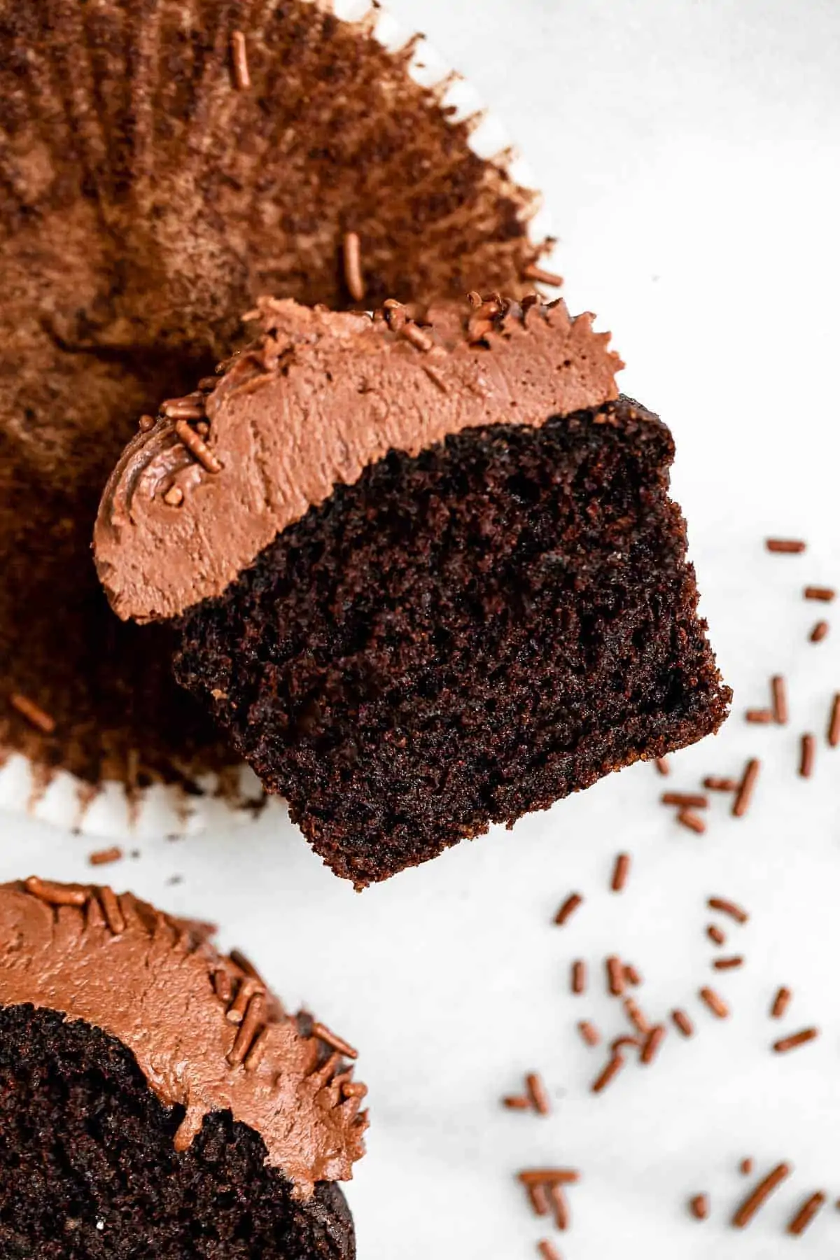 one chocolate cupcake cut in half to show moist texture