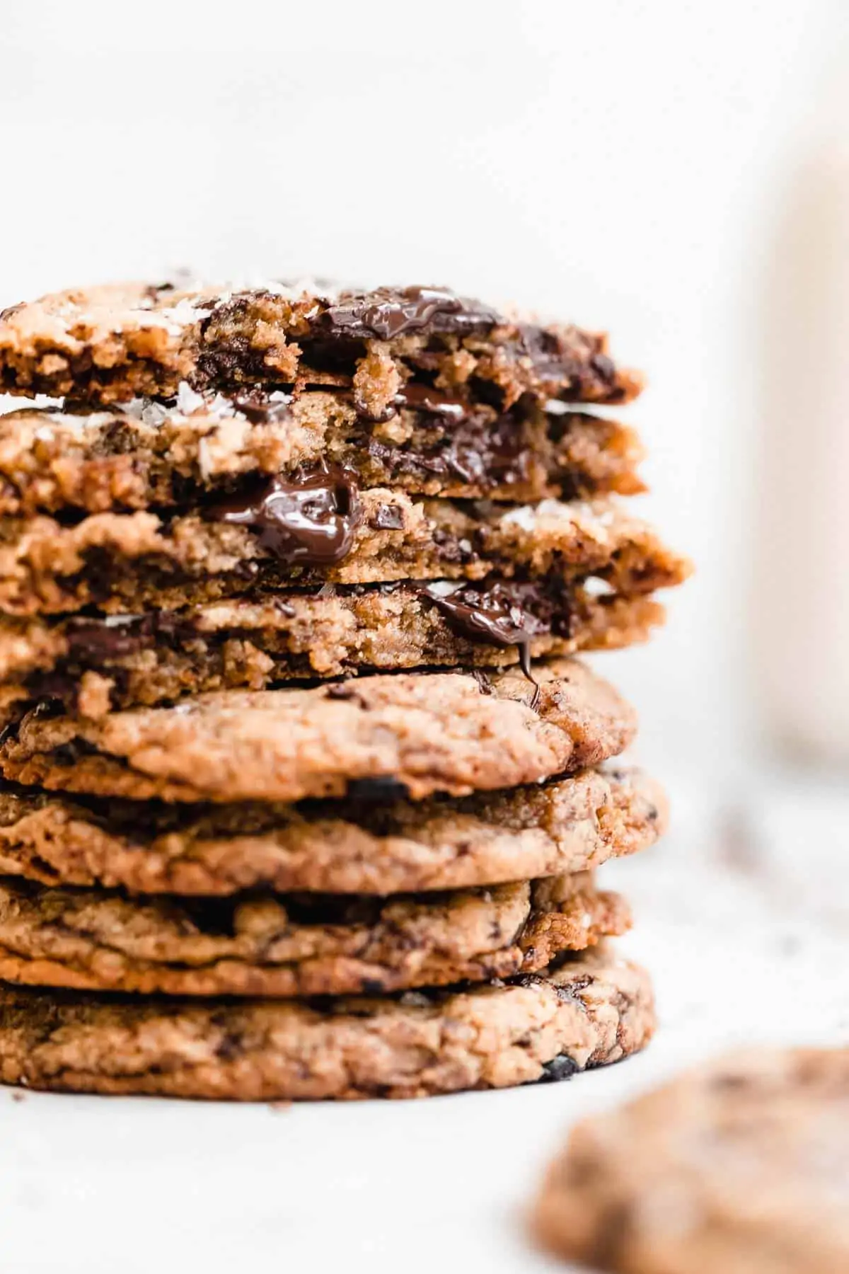 vegan tahini cookies stacked on each other with melted chocolate