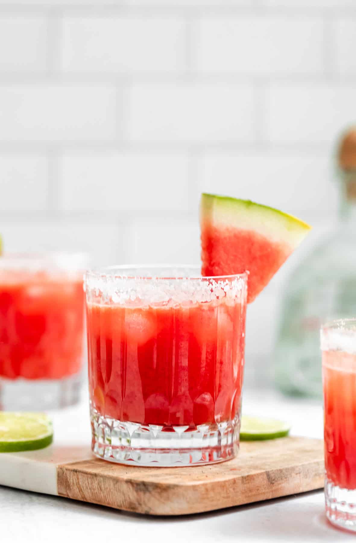 three watermelon margaritas in glasses with salted rims
