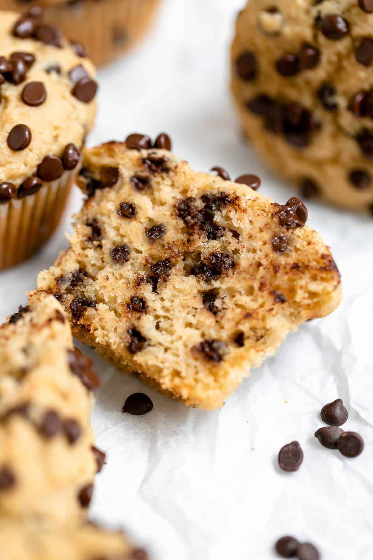 one muffin cut in half to show fluffy texture with chocolate chips