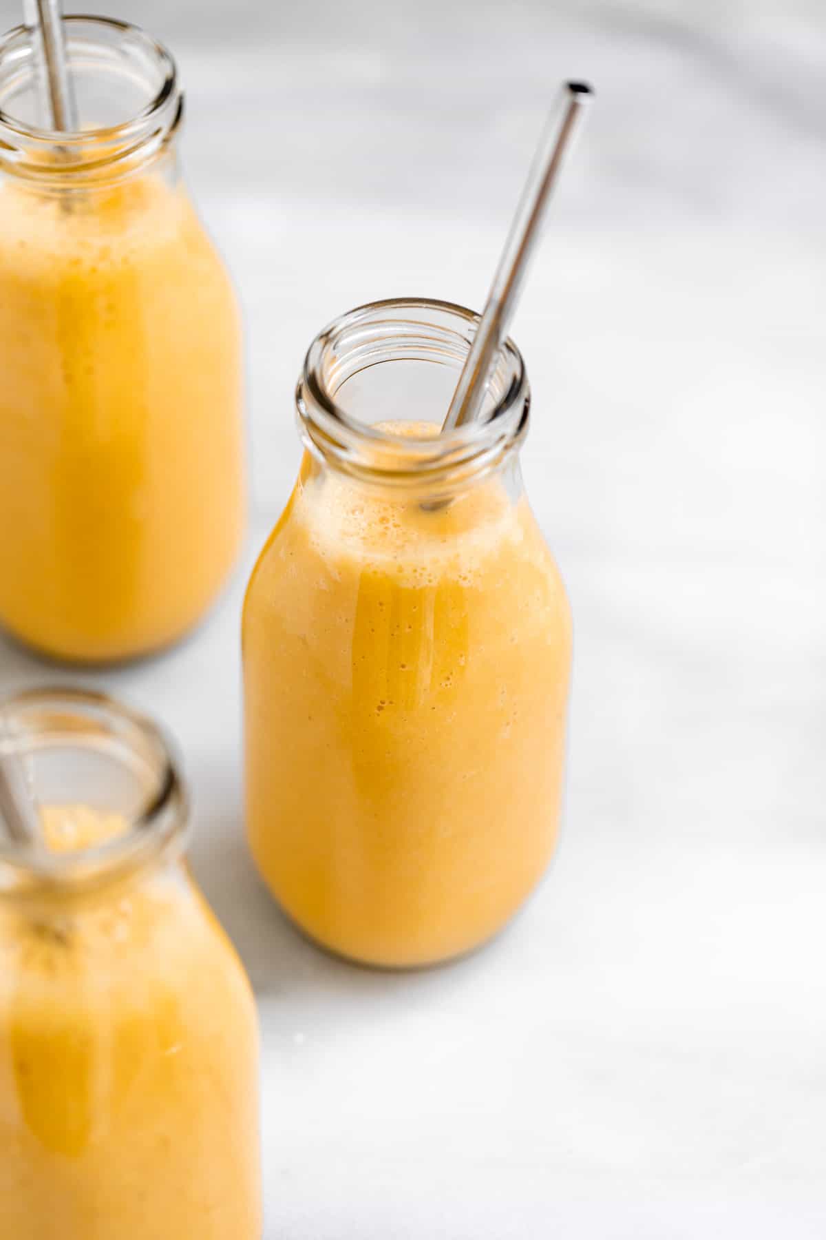 three jars with the orange smoothie recipe 