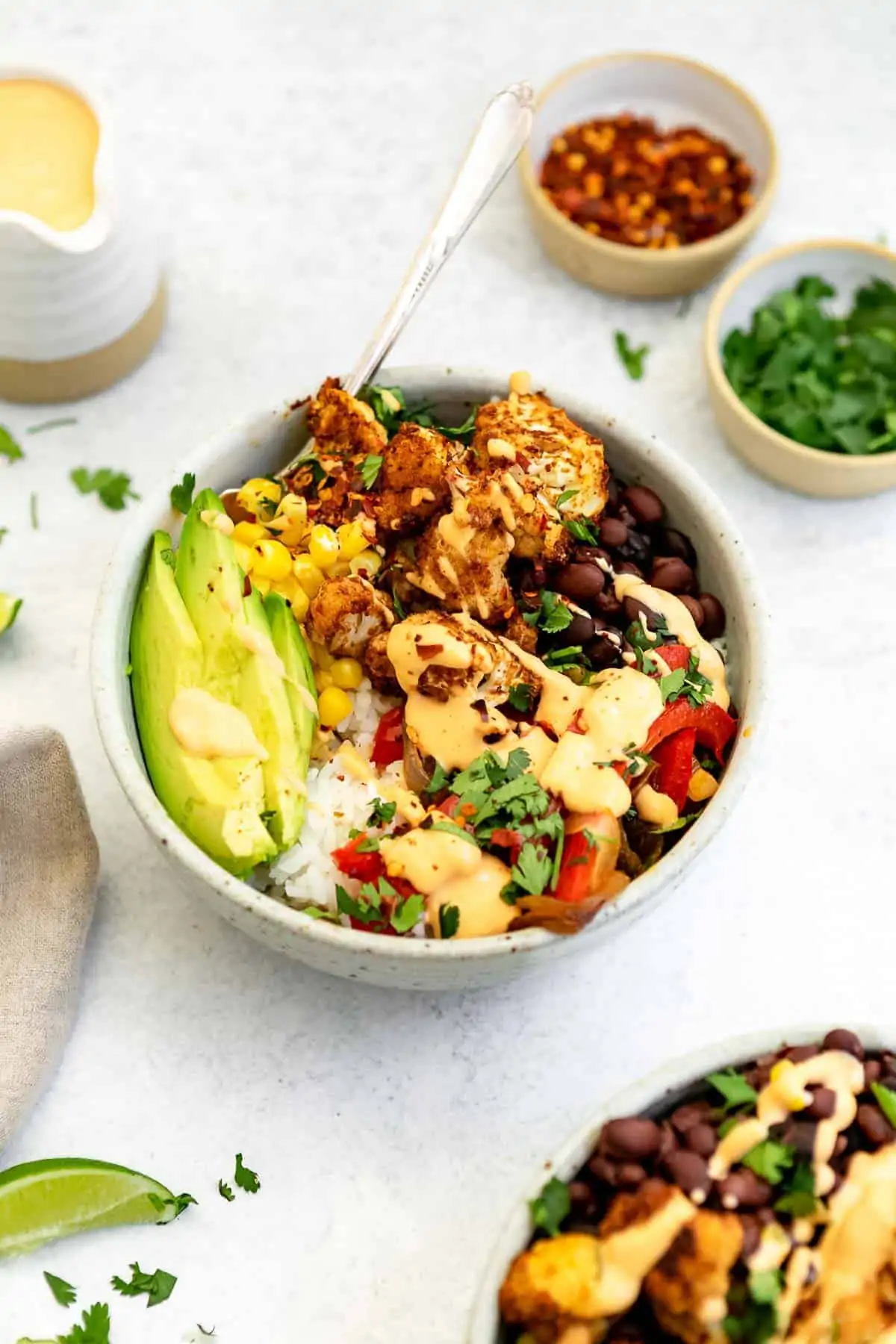 Two burrito bowls with vegetarian chipotle dressing.