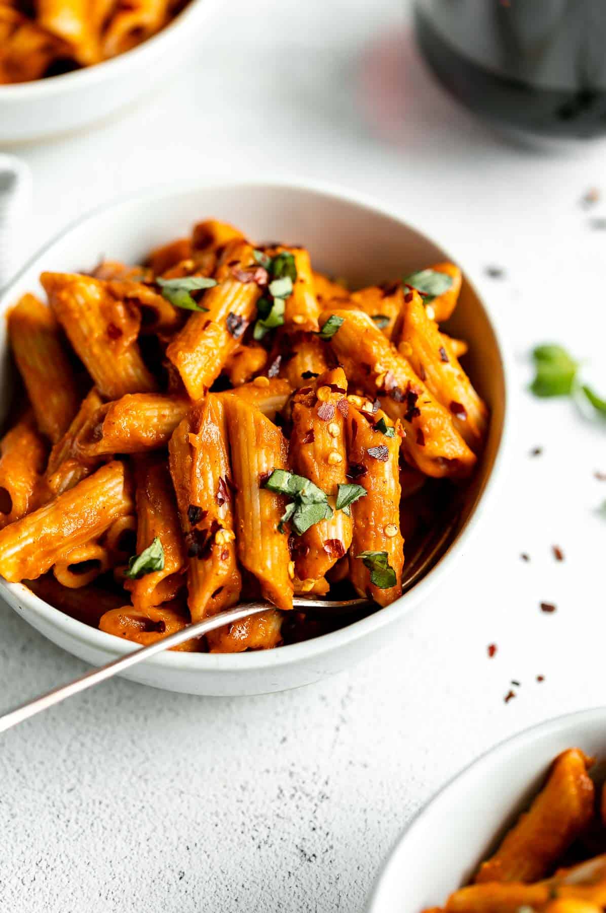 vegan pasta sauce on penne pasta with basil