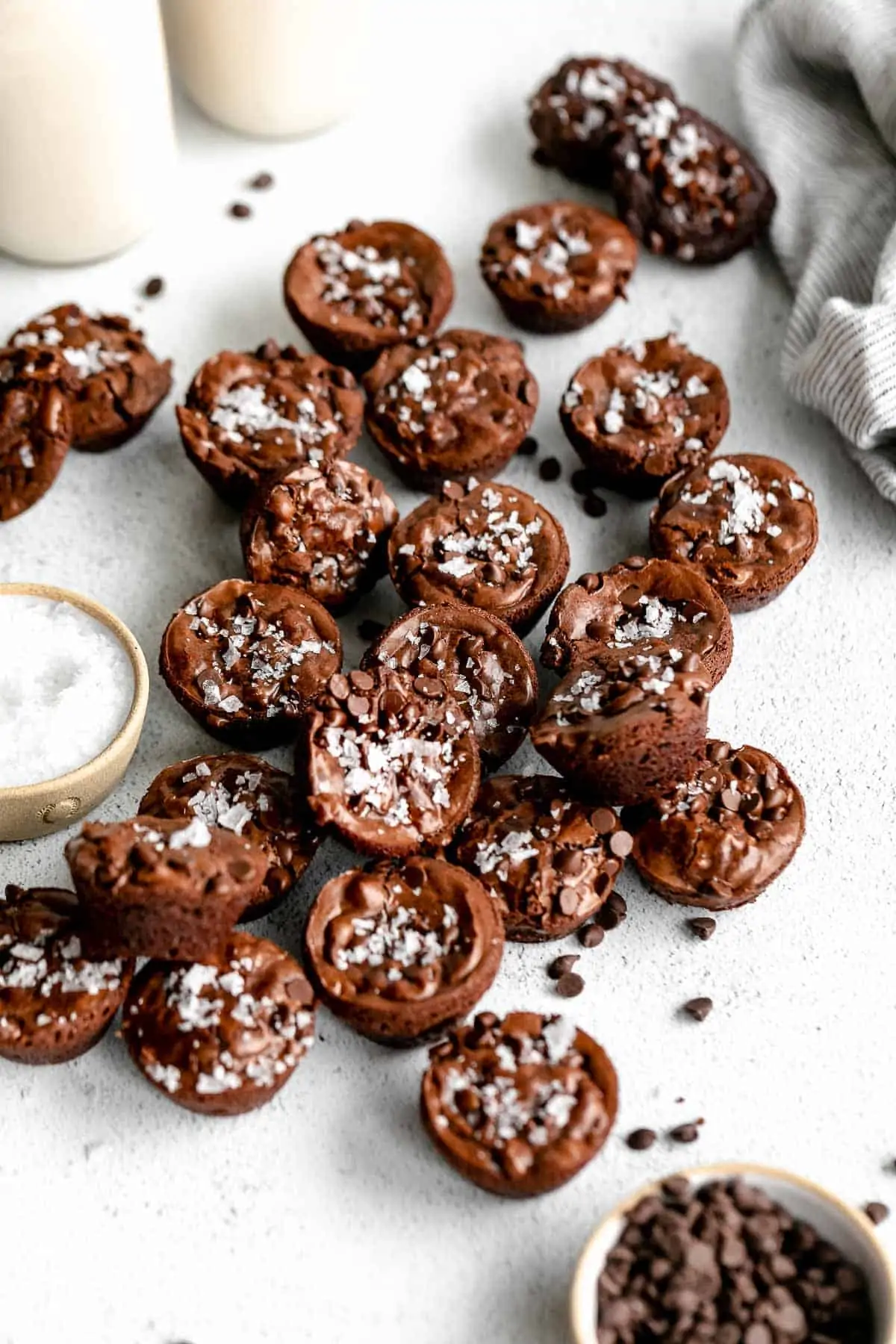 brownie bites on a white backdrop with milk in the back