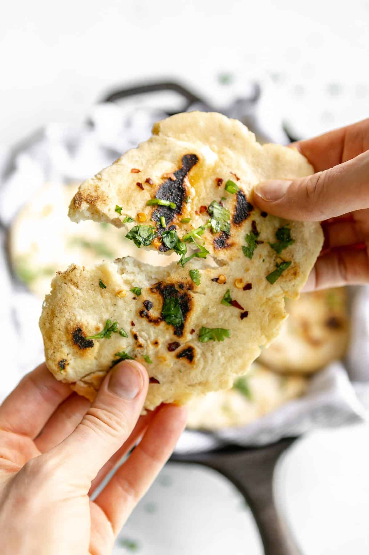 ripping apart a piece of the gluten free naan bread to show texture