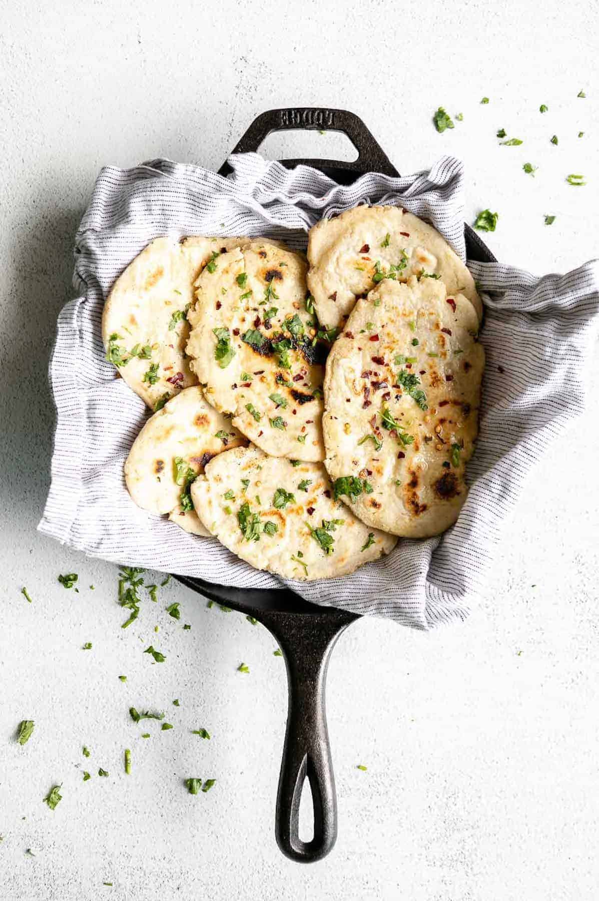 gluten free naan bread in a skillet with cilantro