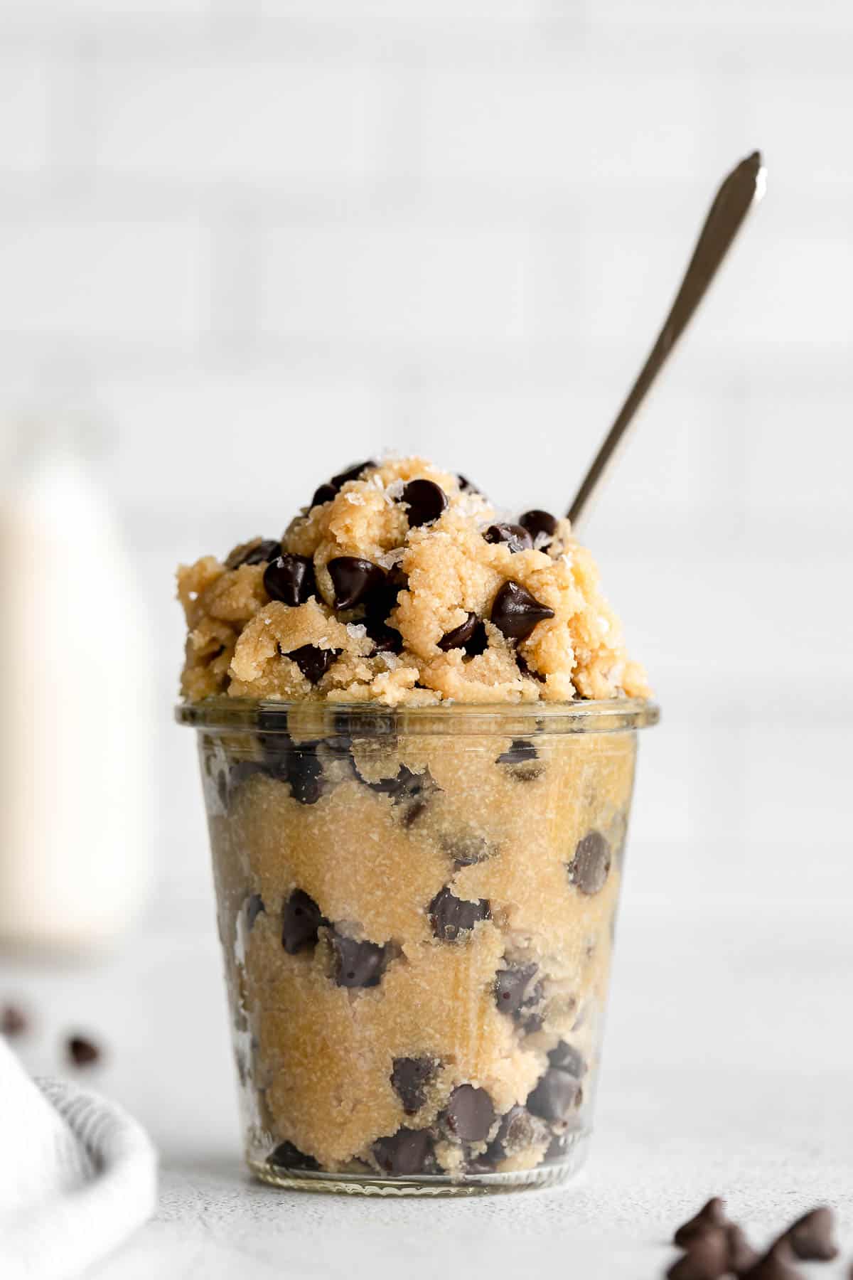 vegan cookie dough in a glass jar with a spoon