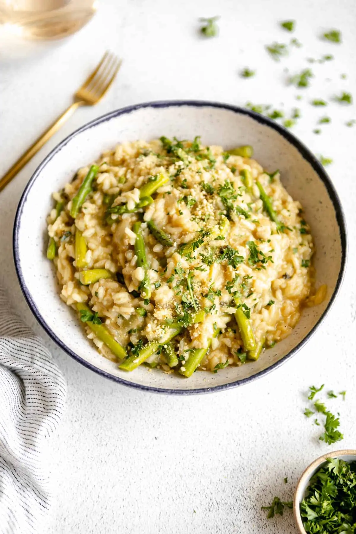 vegan risotto with asparagus and herbs in a bowl