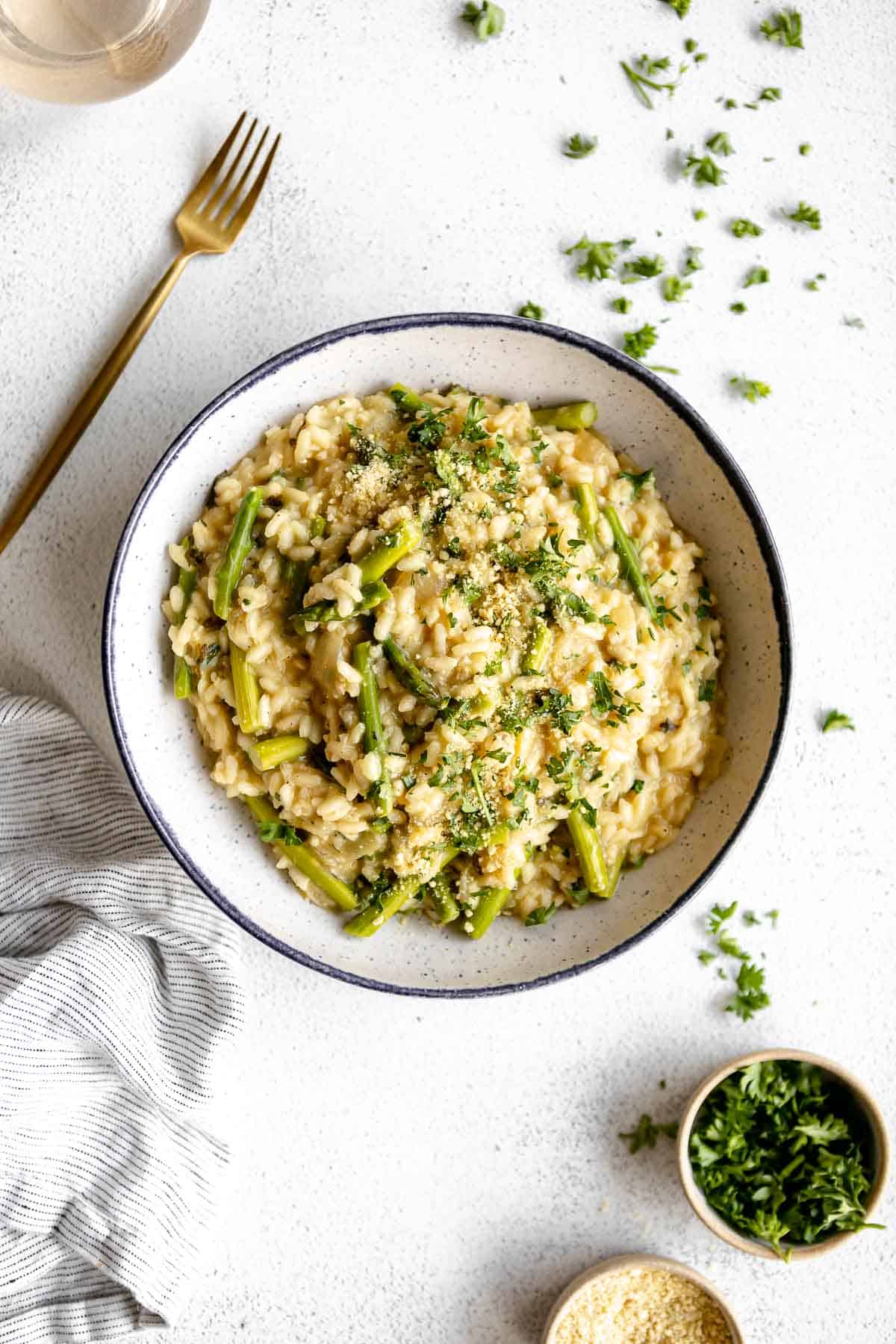 vegan risotto in a blue bowl with herbs 
