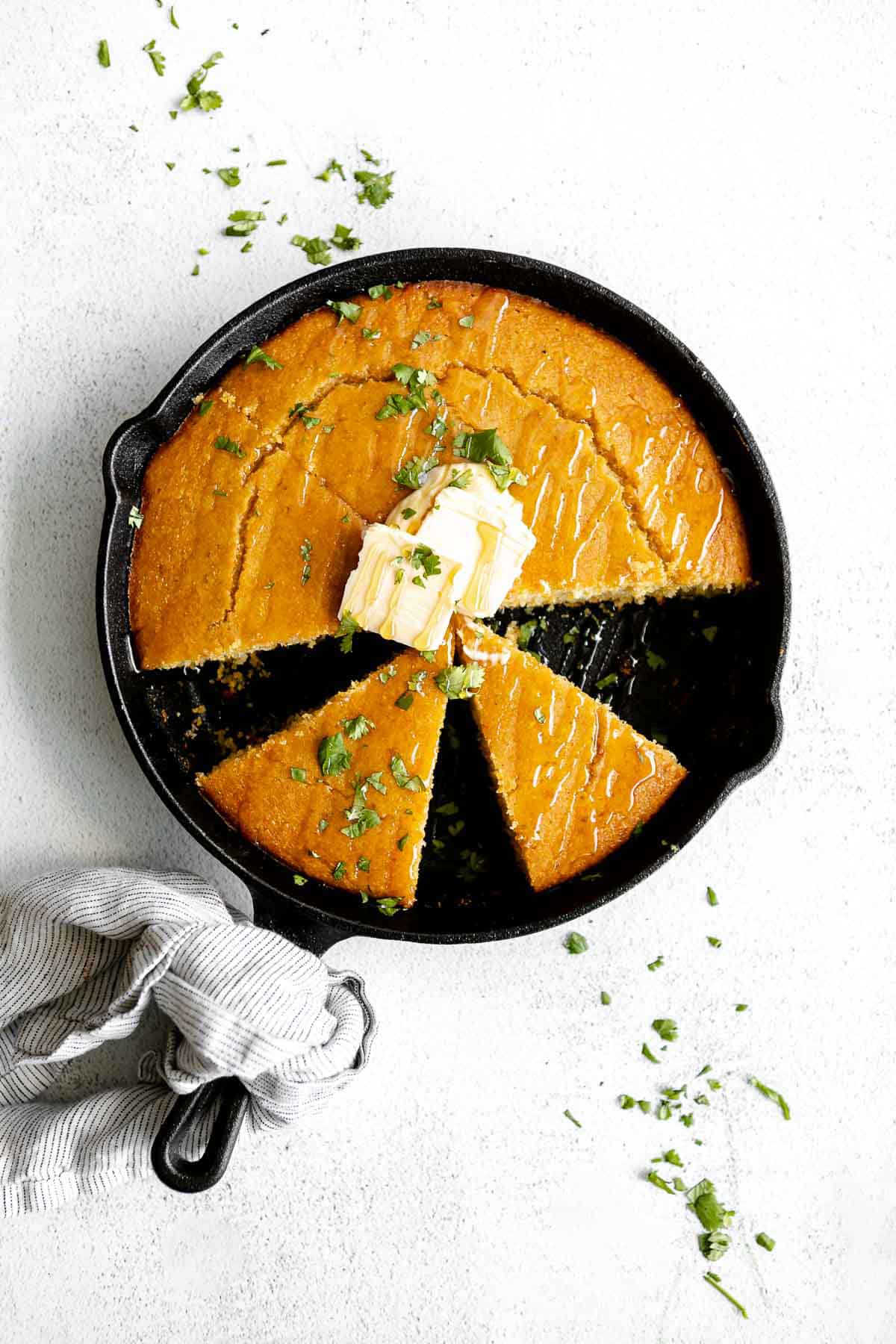 gluten free cornbread in a skillet with butter