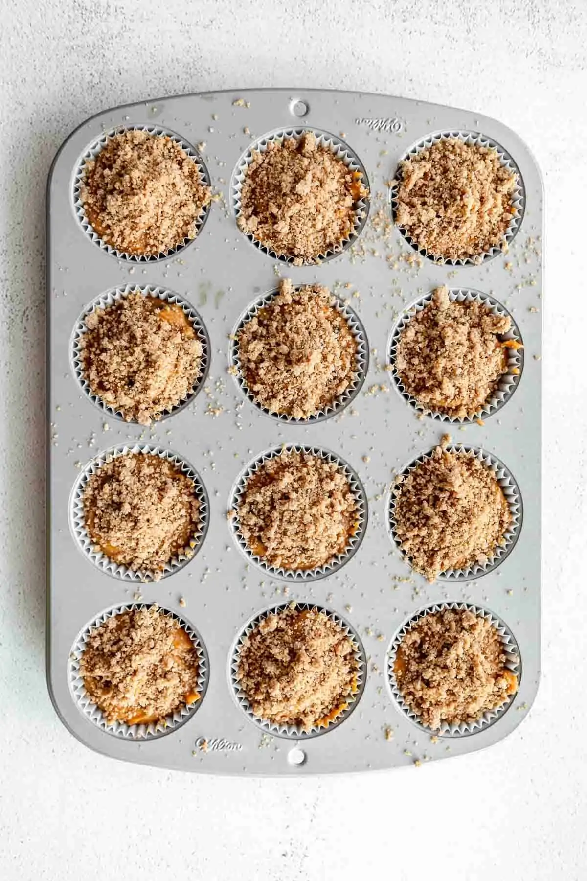 pumpkin muffins in a muffin tray before going in the oven