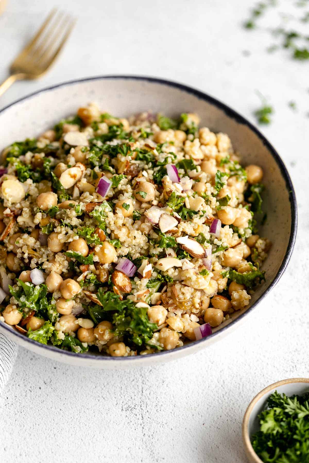 quinoa chickpea salad with kale in a blue bowl