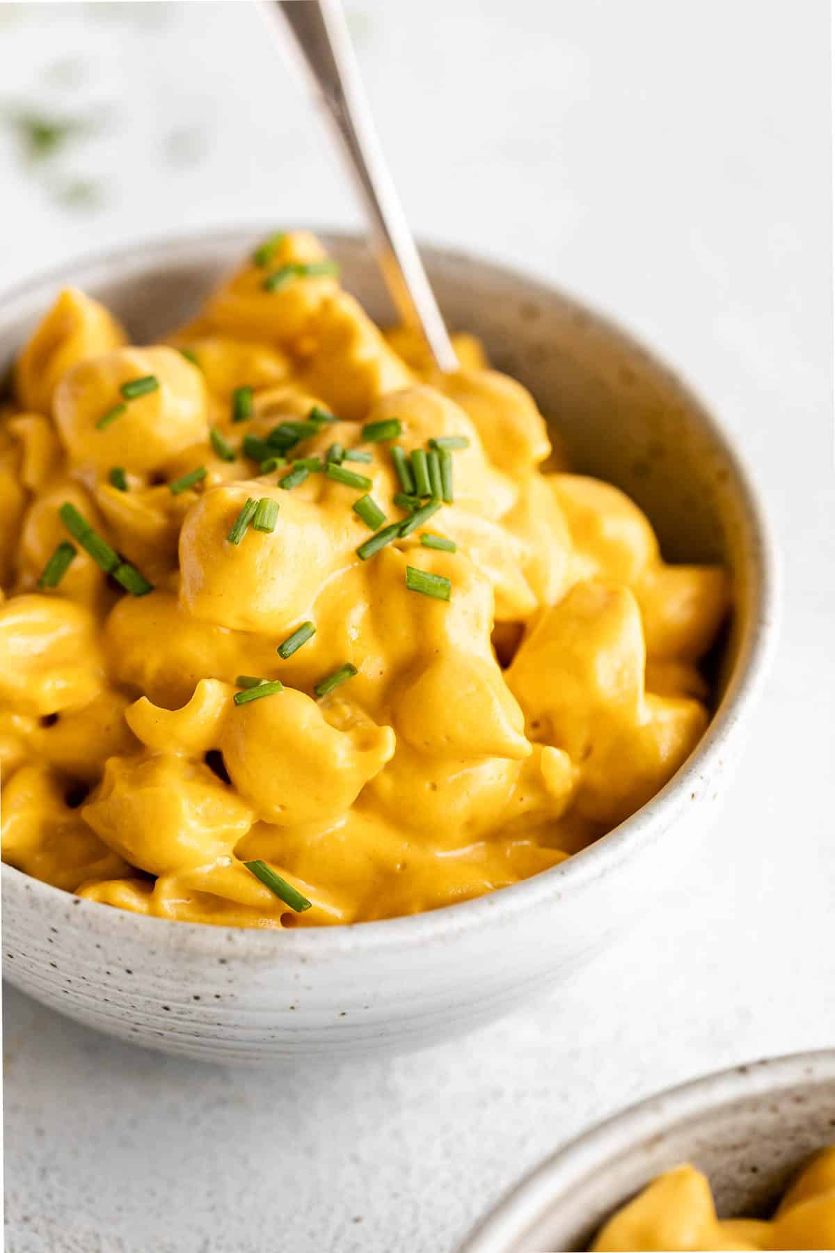 vegan butternut squash mac and cheese in a bowl with chives