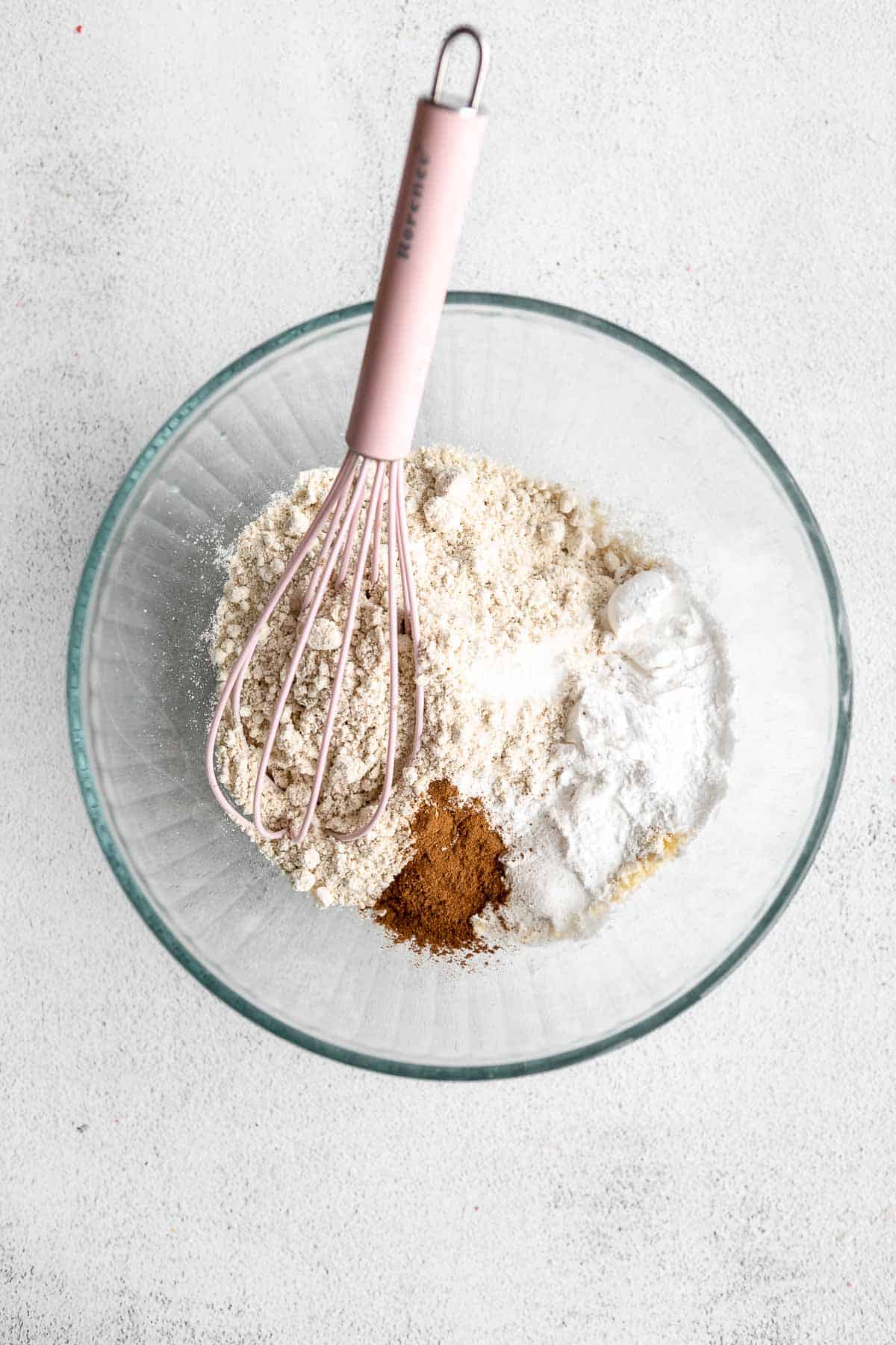 dry ingredients in a glass bowl with a whisk