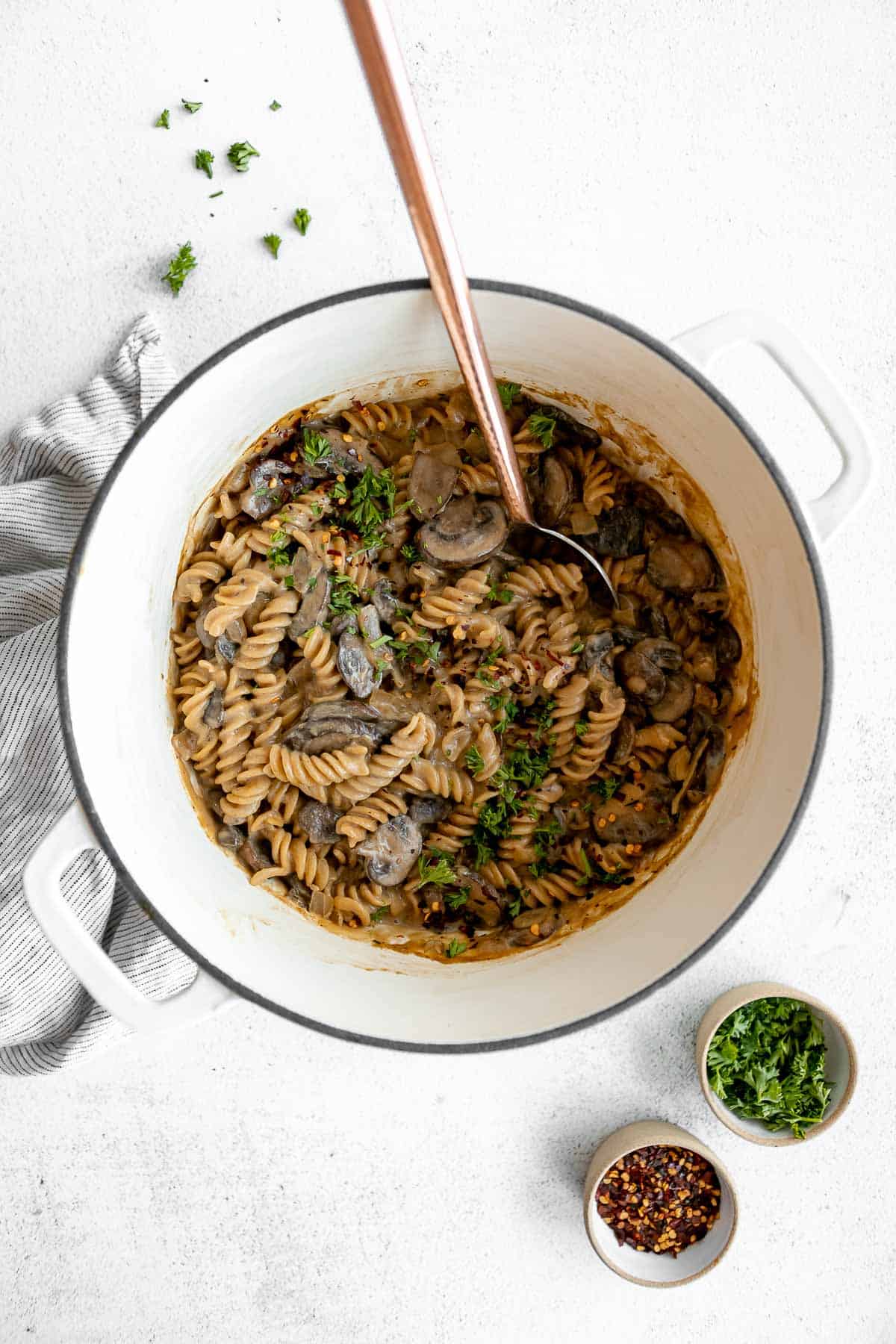 vegan mushroom stroganoff in a pot with a spoon on the side