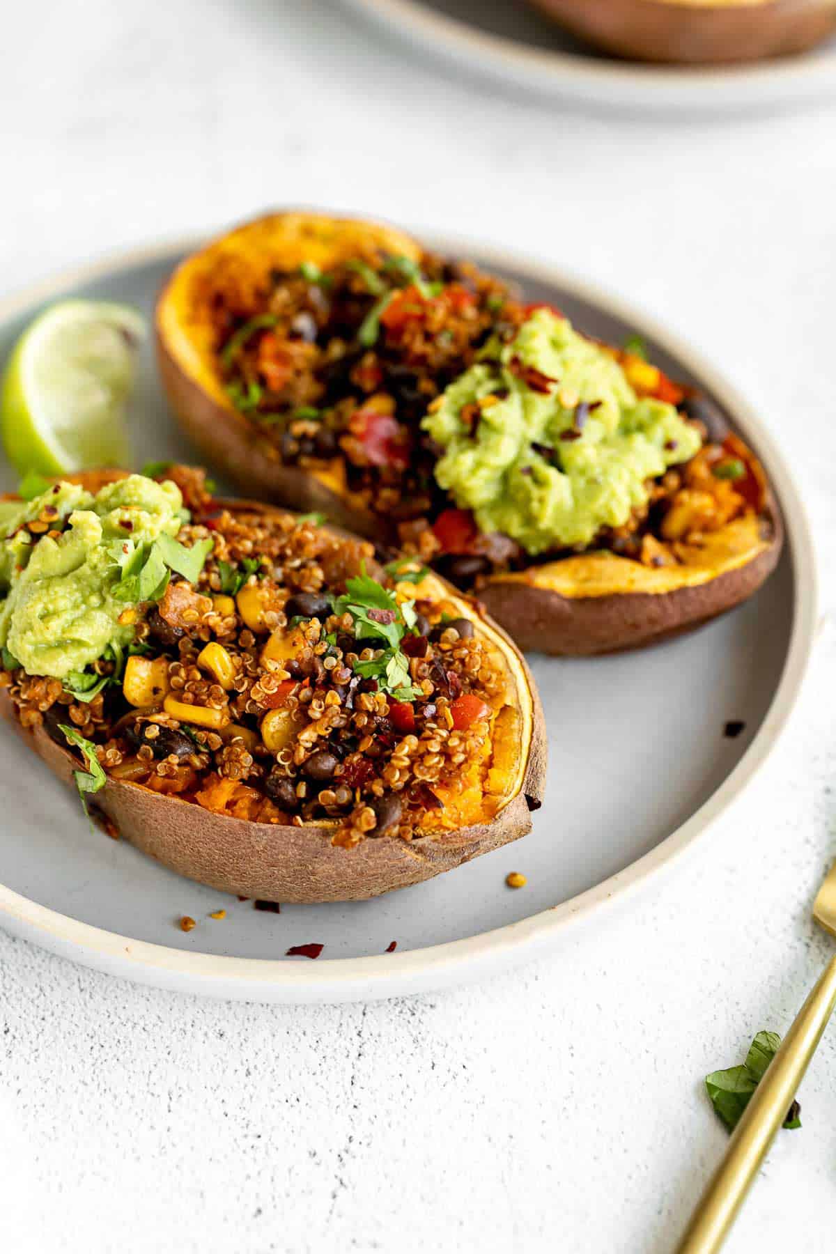 vegan mexican quinoa stuffed sweet potatoes with guacamole