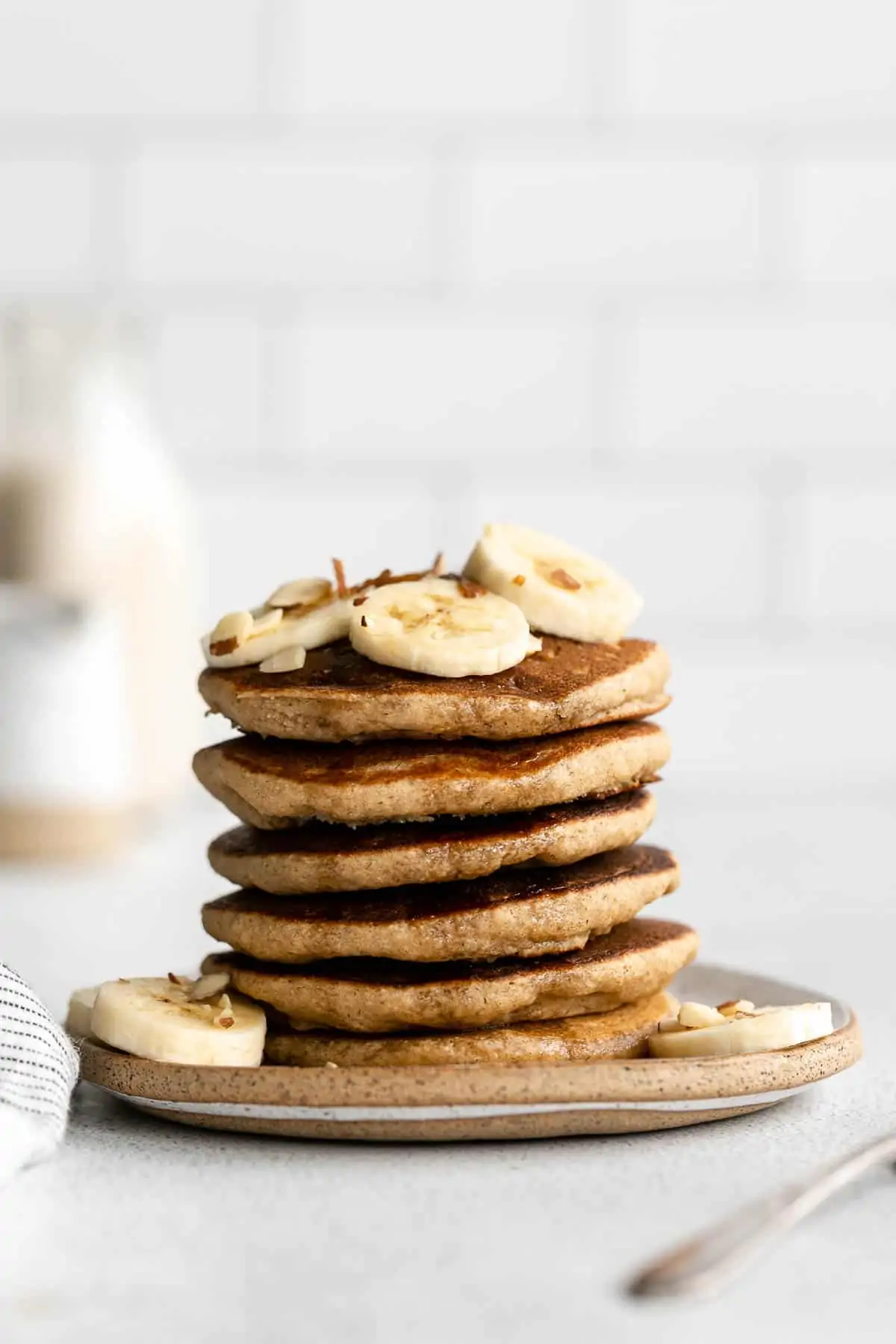 gluten free pancakes on a plate with banana slices on top 