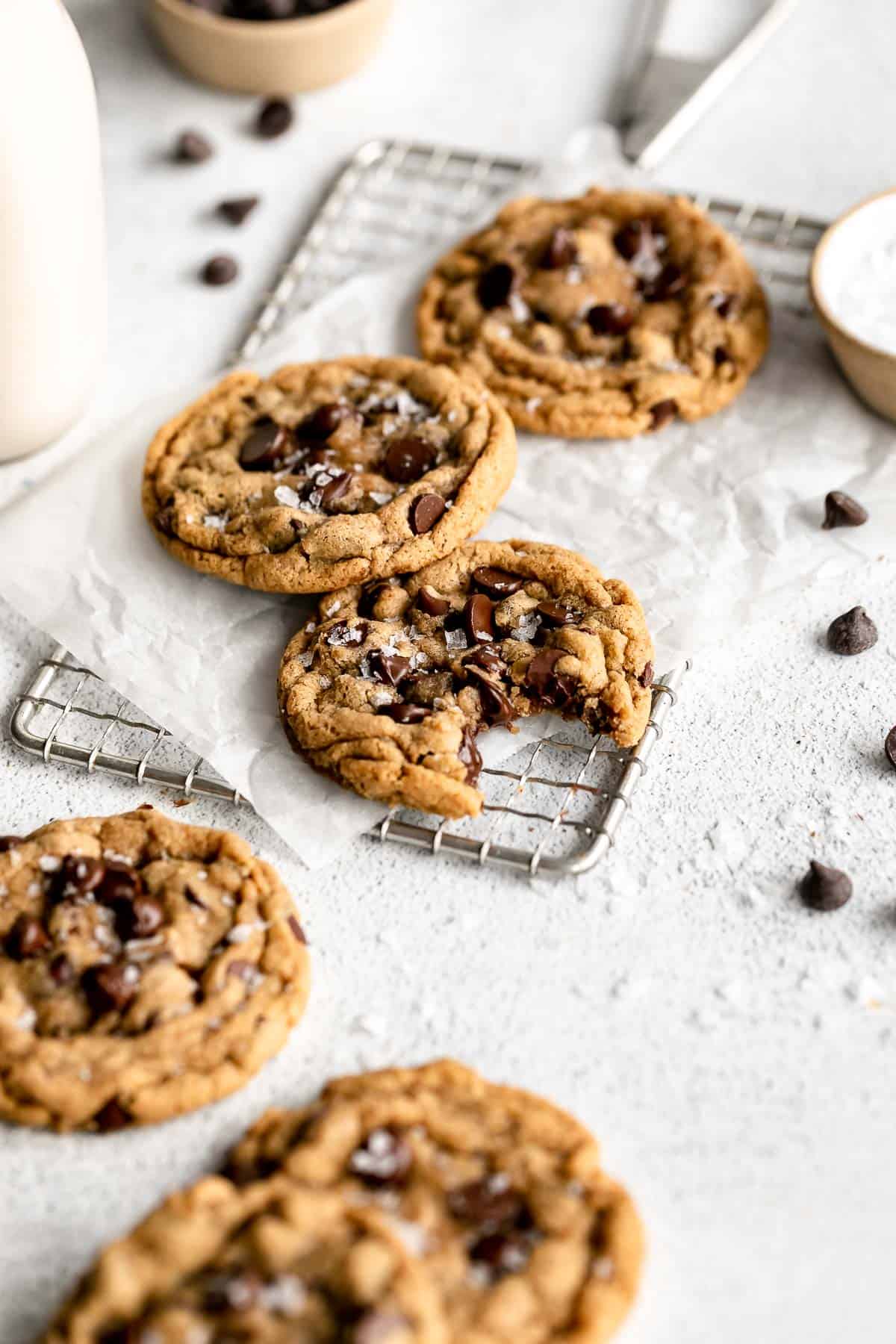 chocolate chip cookies with milk in the background