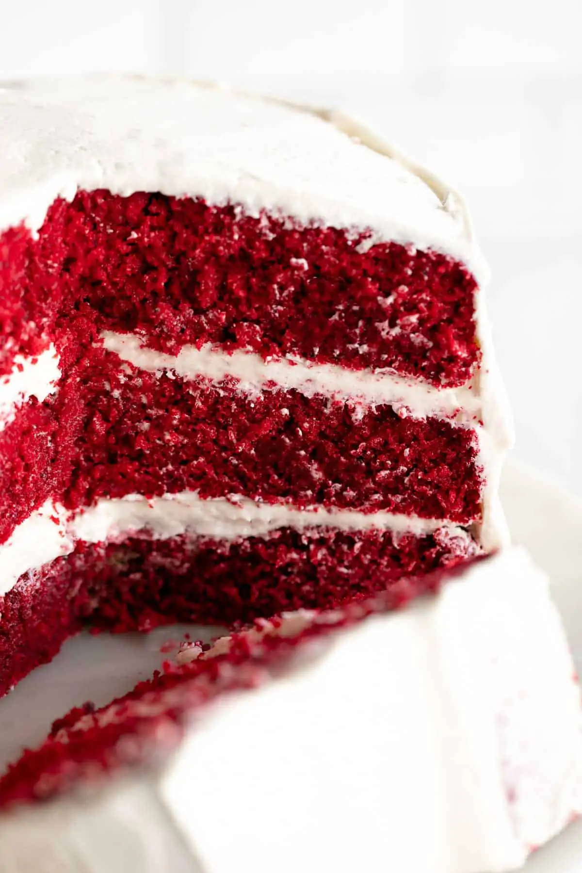 up close of sliced gluten free red velvet cake with cream cheese frosting