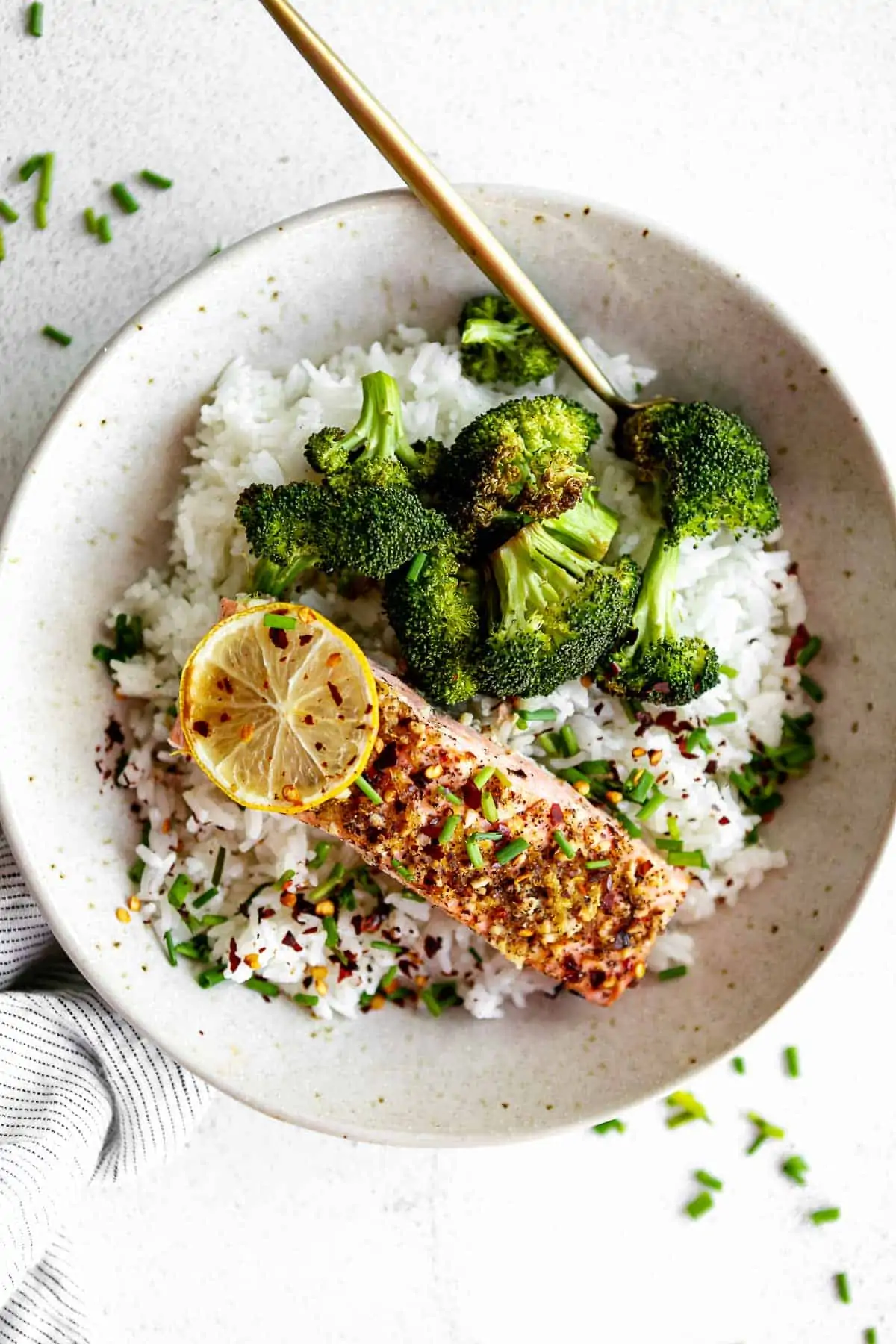 lemon pepper salmon in a bowl with rice and broccoli