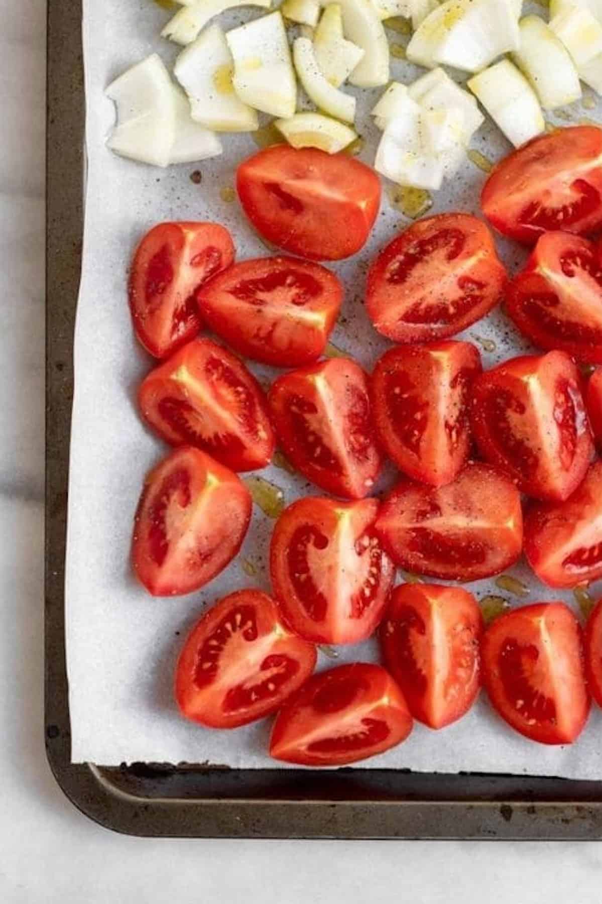 Roasted tomatoes on a baking sheet.