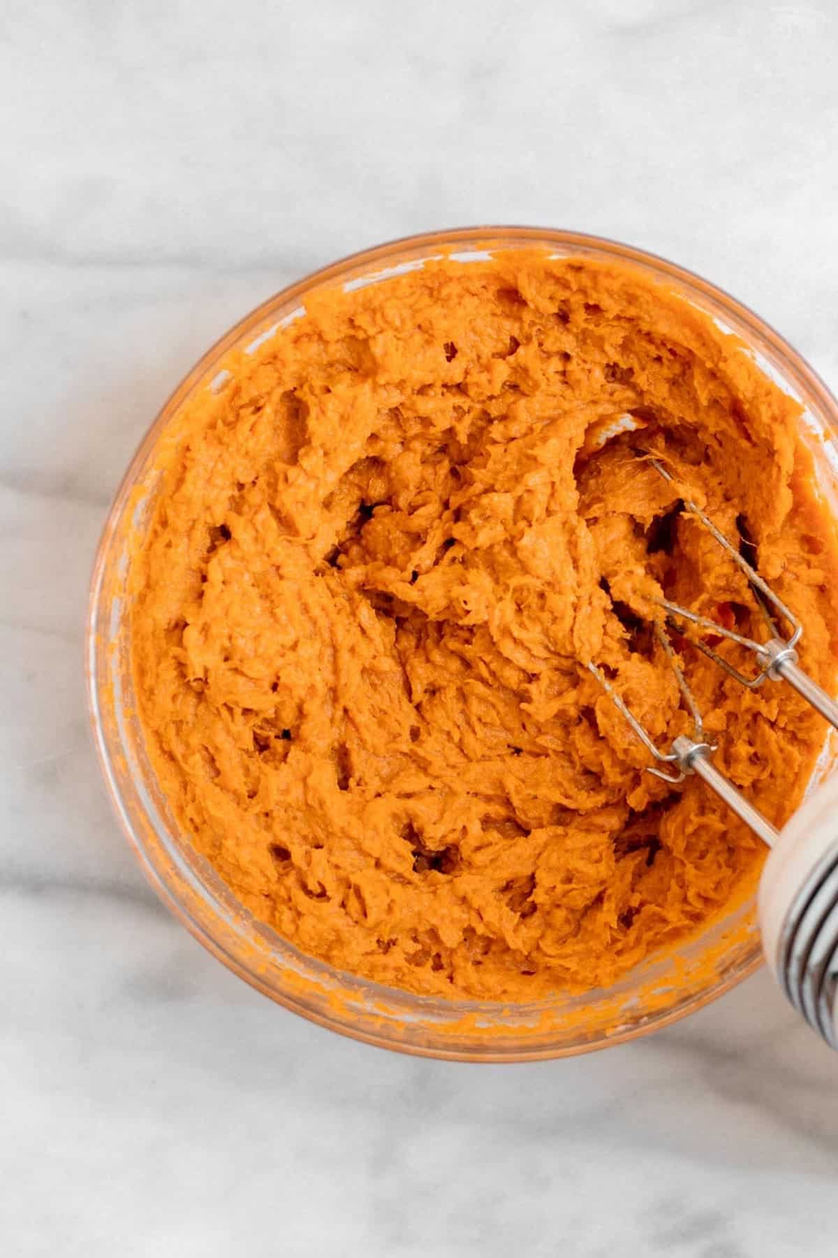 Sweet potato whipped in a glass bowl.