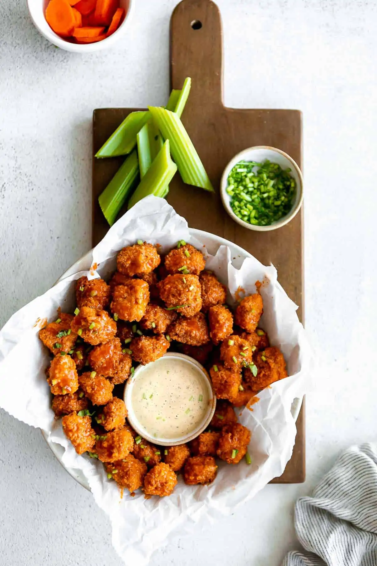 buffalo popcorn chicken in a bowl with ranch