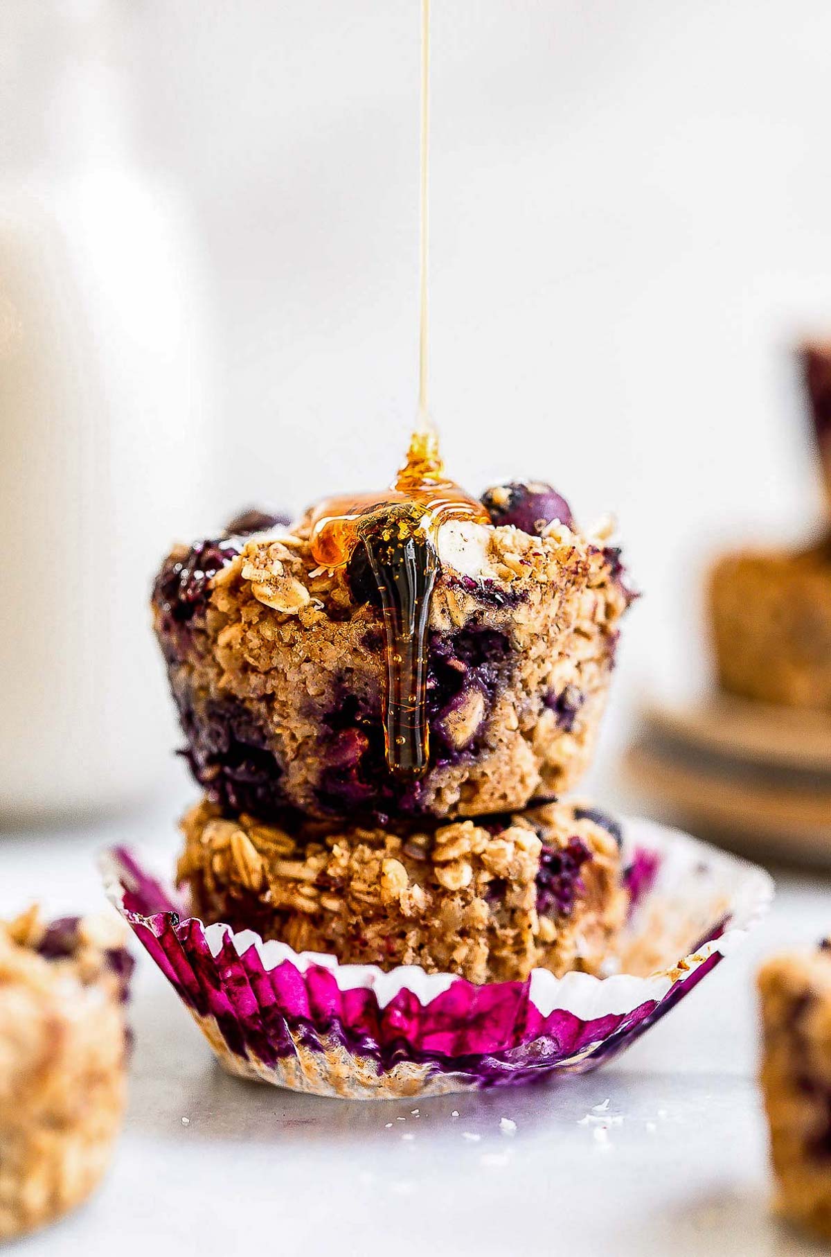 baked blueberry oatmeal cups with honey drizzled on top