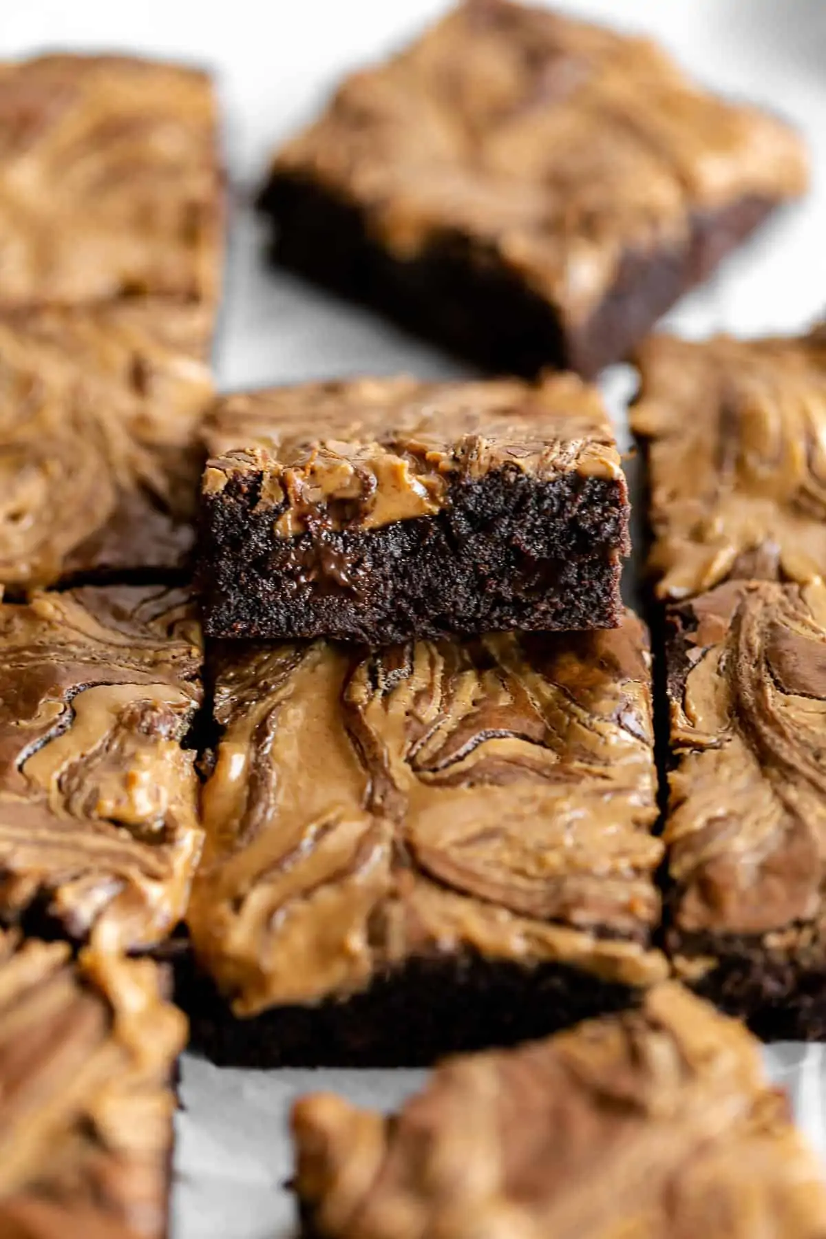 healthy brownies cut into squares with melted chocolate