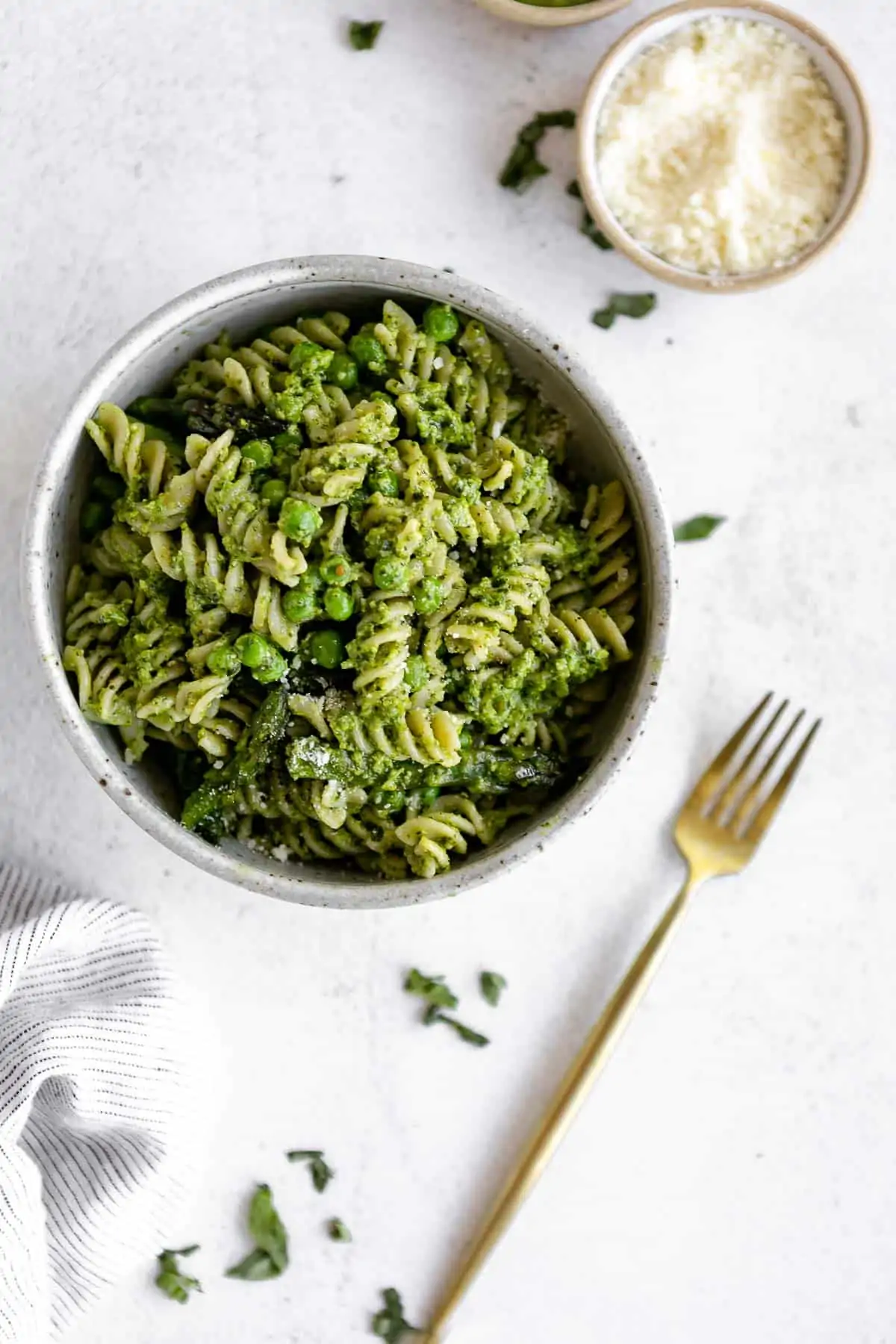 vegan pesto pasta with peas and asparagus in a bowl