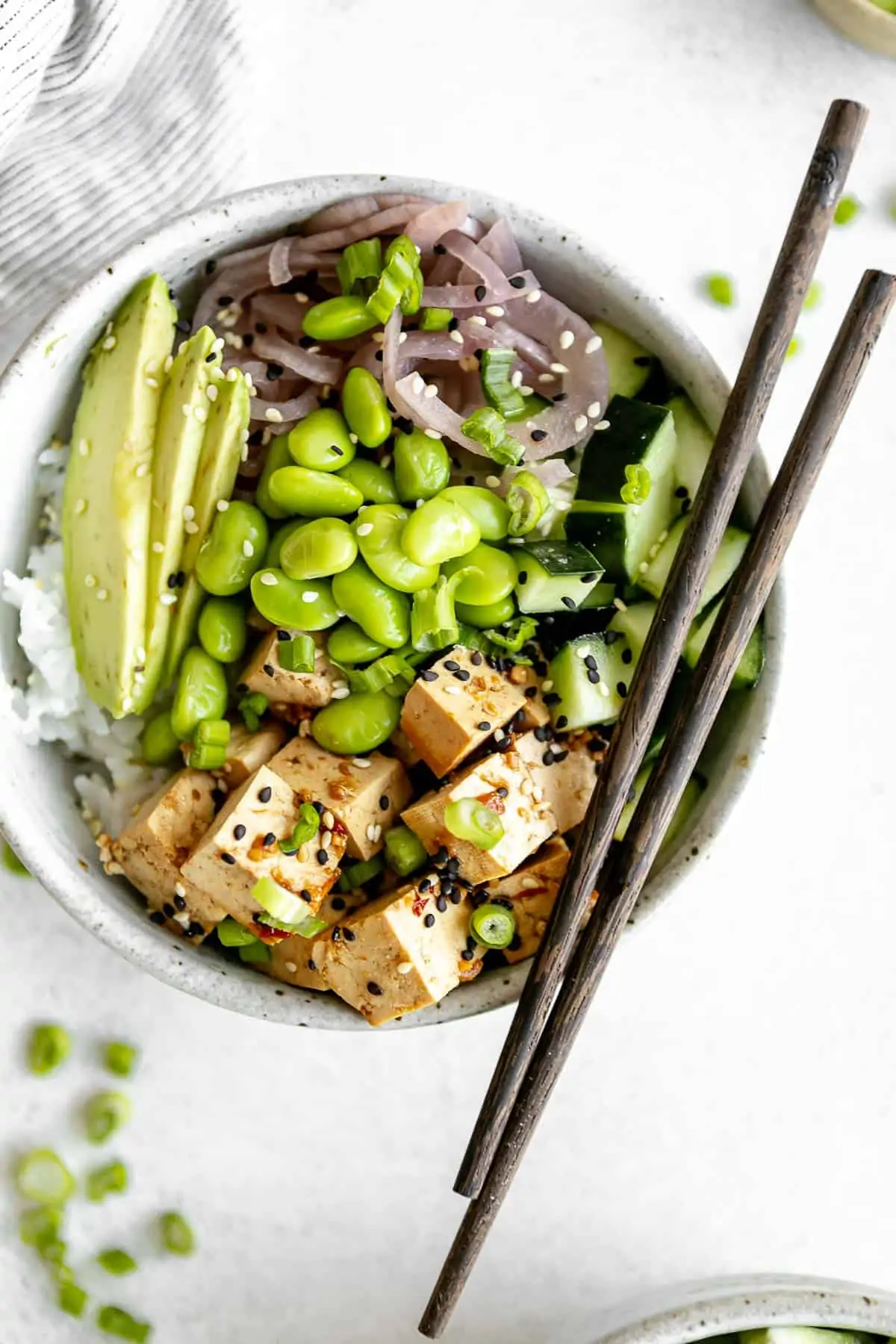 vegan tofu poke bowl with chopsticks on the side