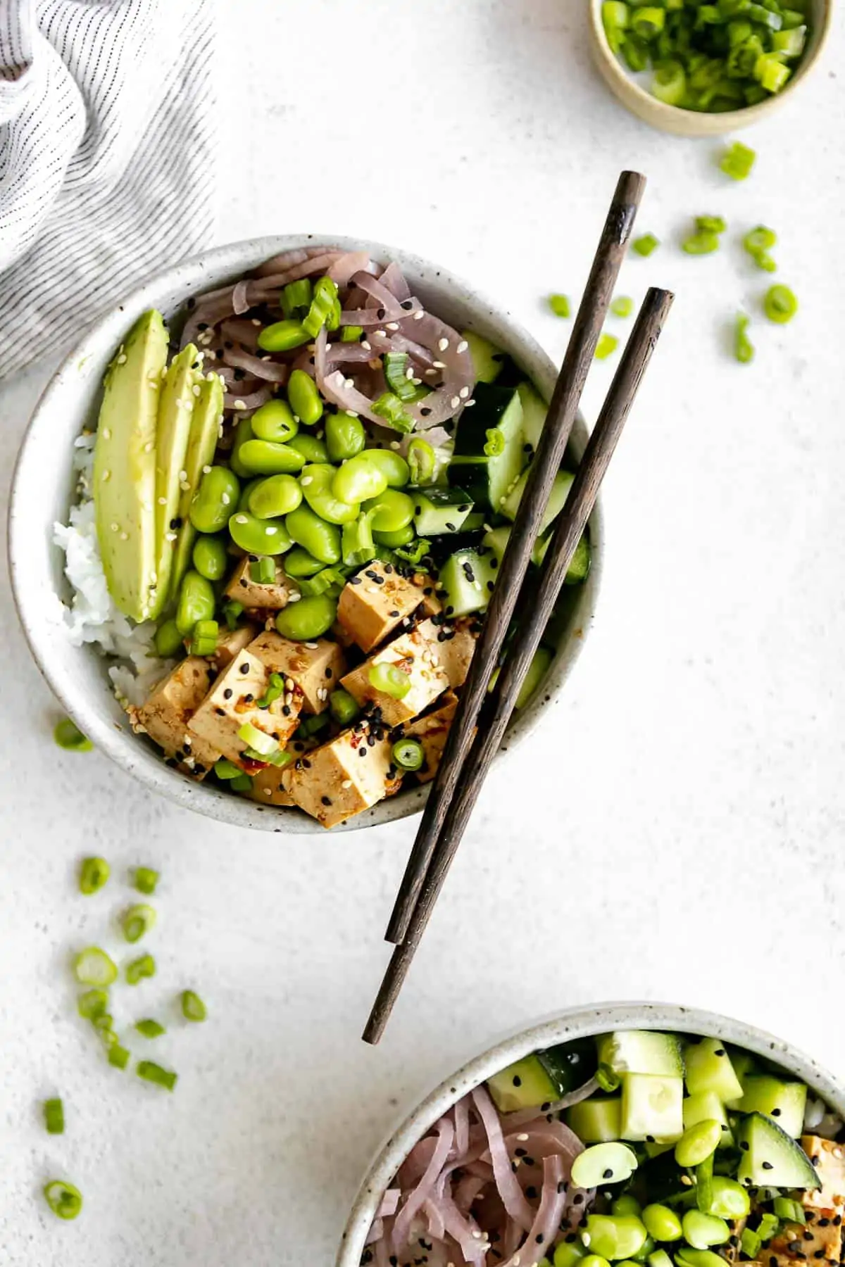 vegan poke bowl with chopsticks and scallions