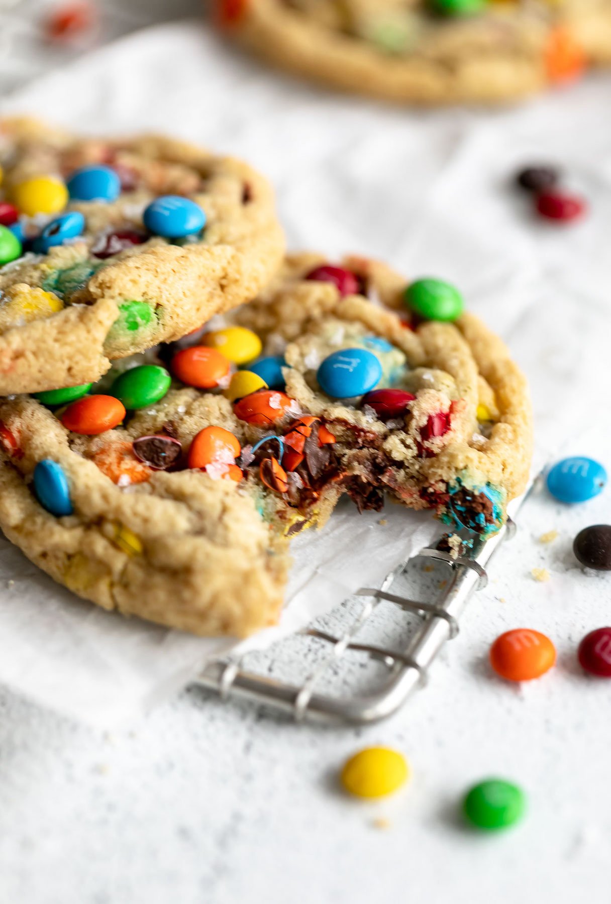 m&m gluten free cookies with a bite taken out to show texture
