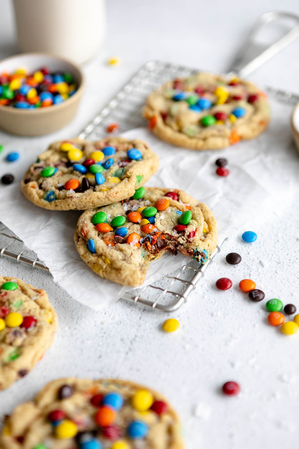 gluten free m&m cookies on a white backdrop with a wire rack