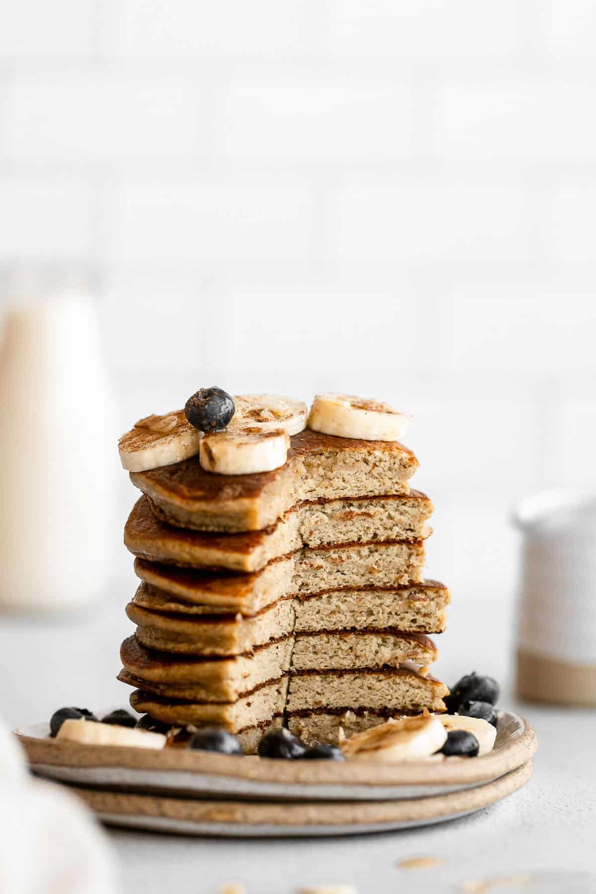stack of pancakes with a cut in the middle to show the fluffy texture