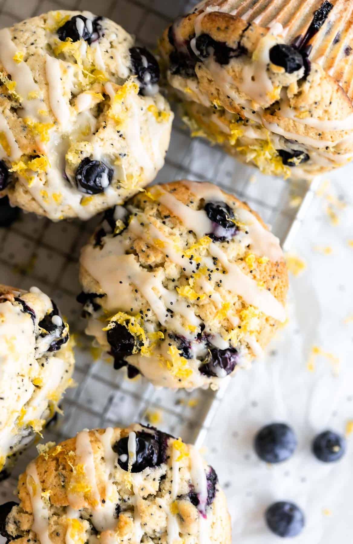 tops of the gluten free lemon blueberry muffins with a lemon glaze drizzled on top