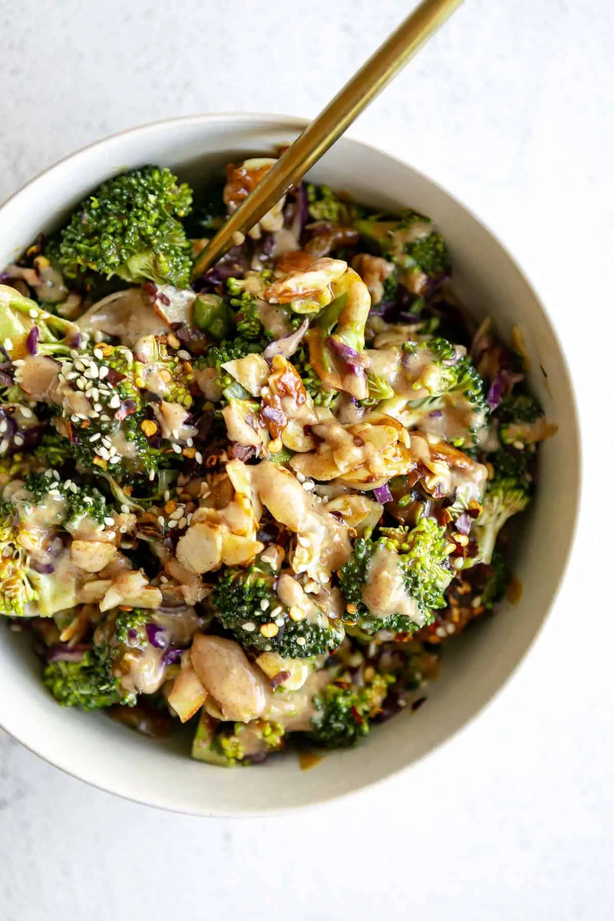 broccoli salad with the almond butter dressing drizzled on top