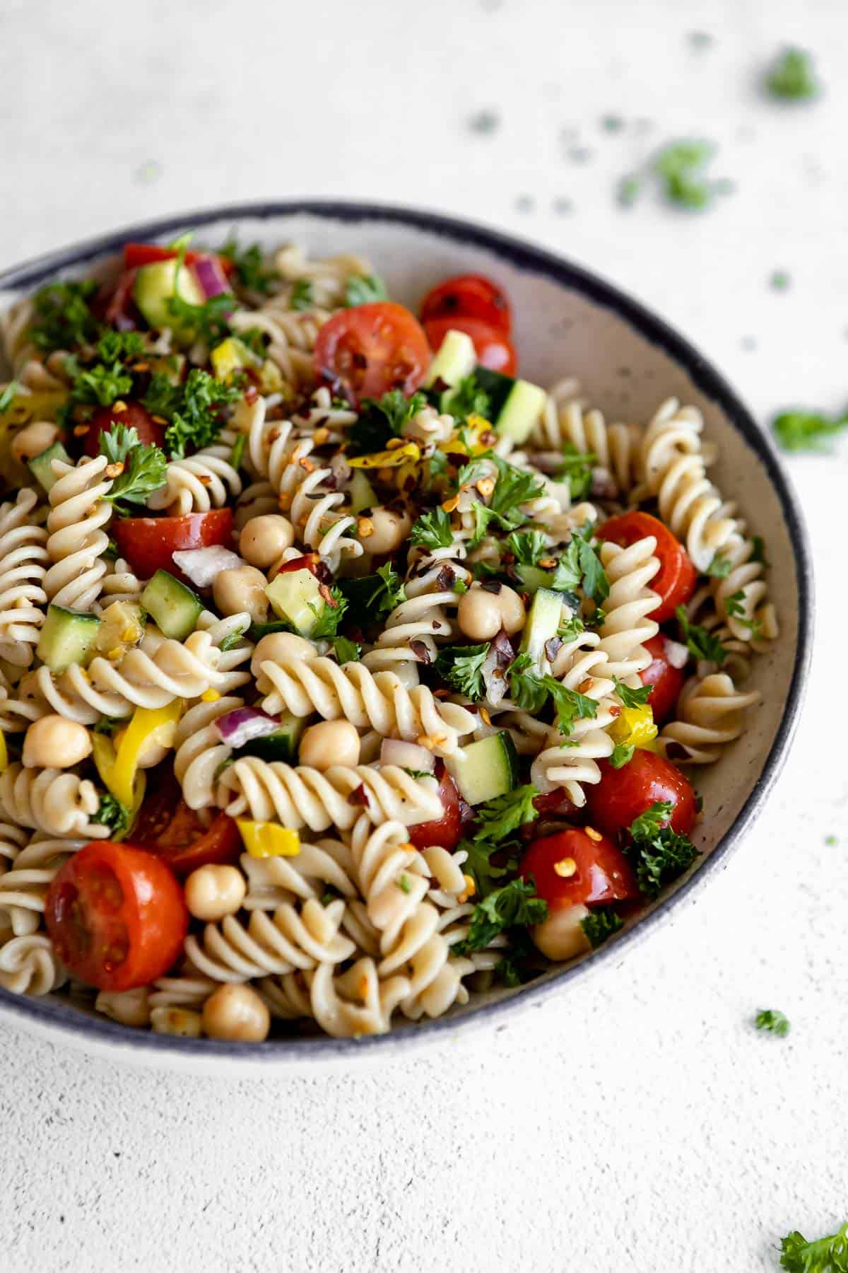 angled view of the pasta salad with tomatoes and cucumber and chickpeas