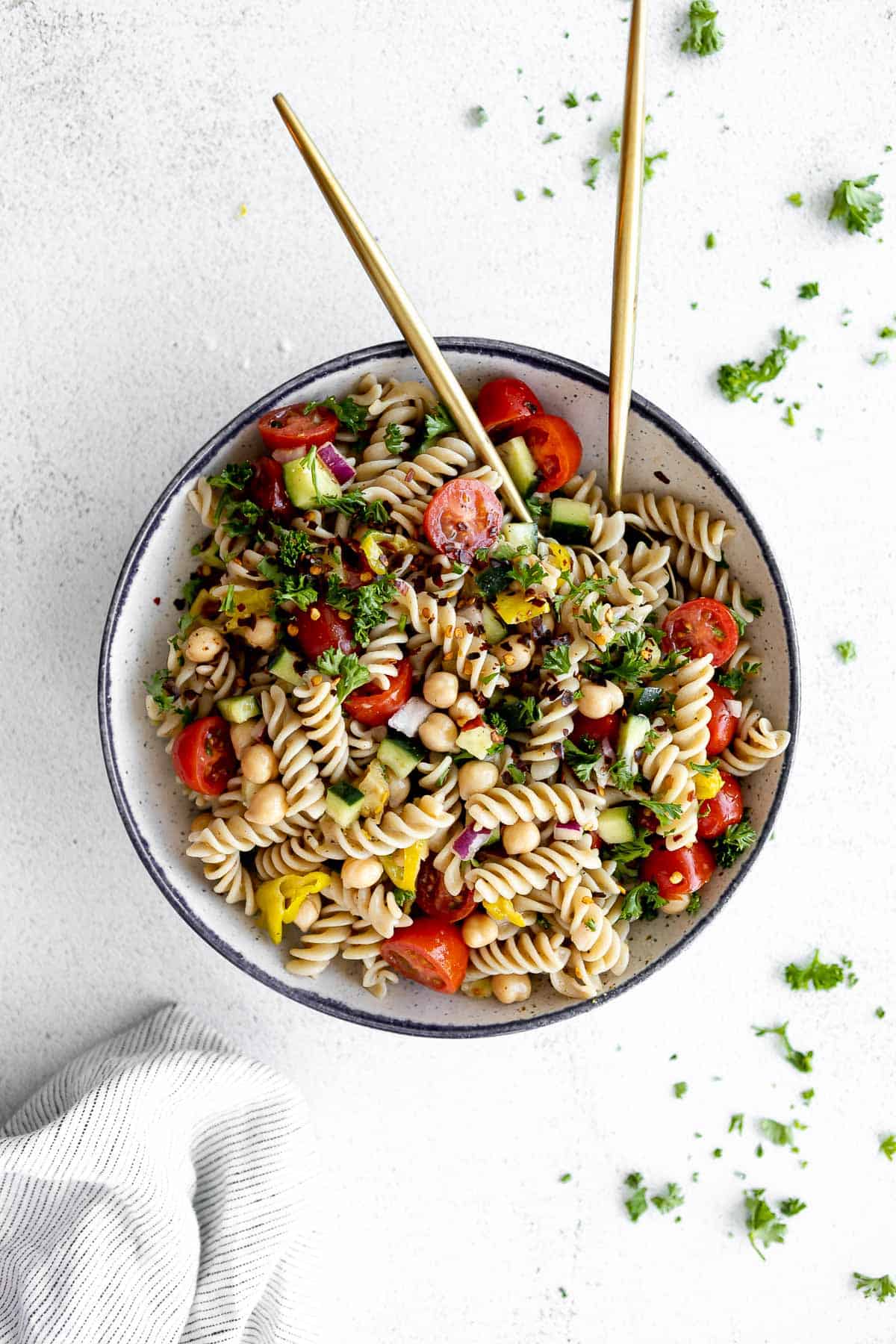vegan chickpea pasta salad with fresh parsley on top in a bowl