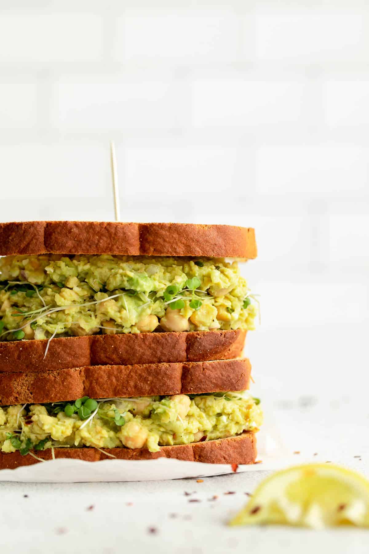 two chickpea avocado salad sandwiches stacked on each other