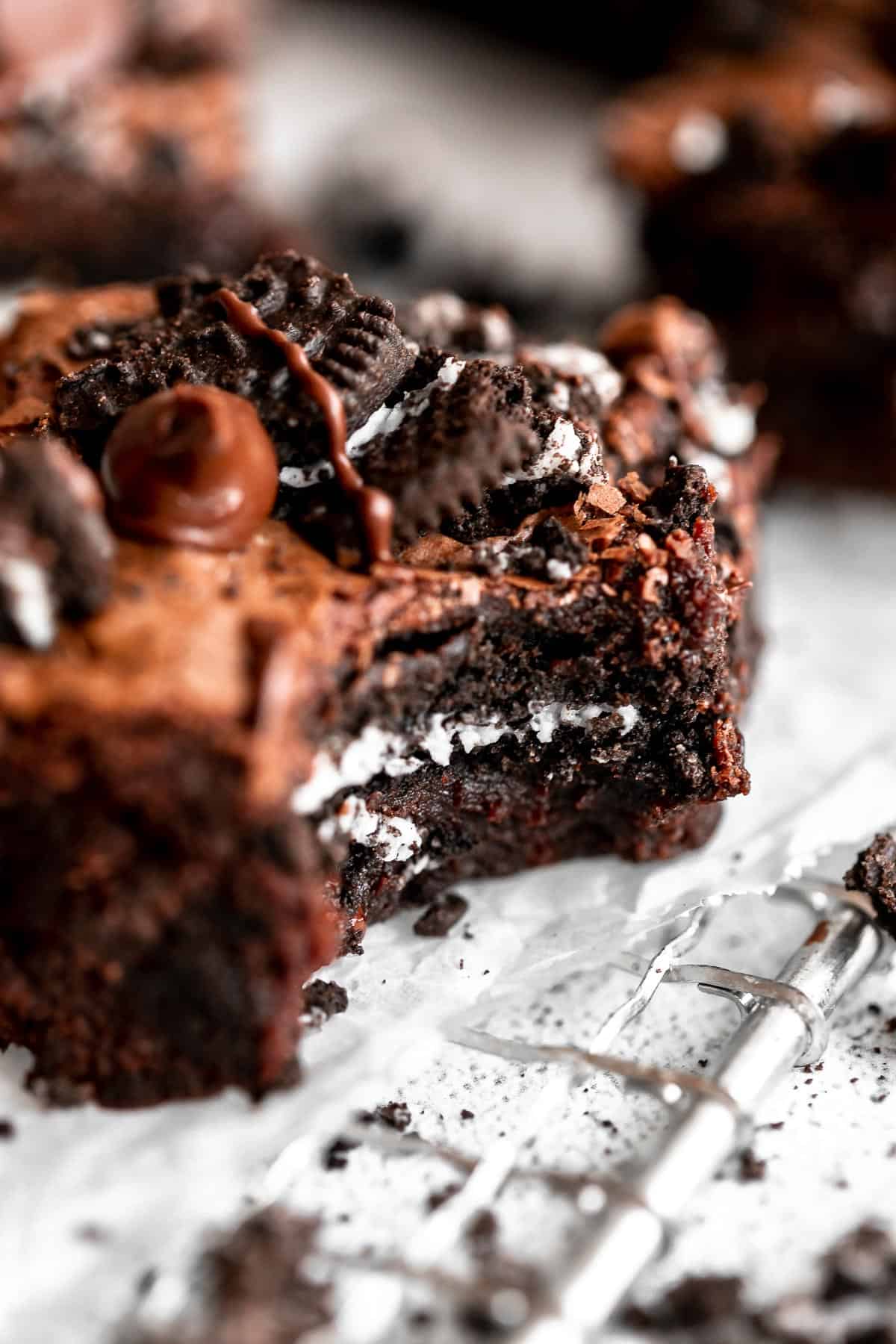 up close image of one gluten free brownie with a bite taken out to show the center oreo
