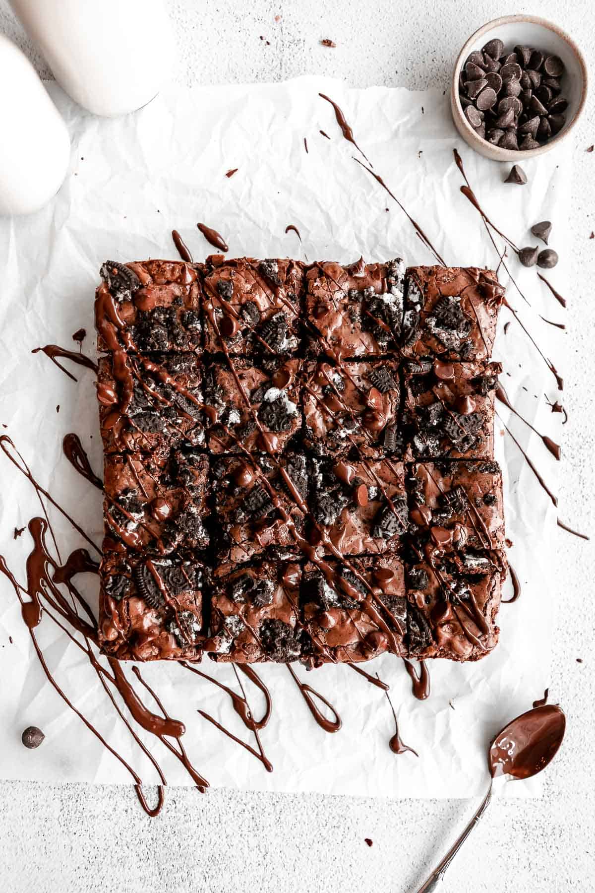 gluten free oreo brownies cut into squares with chocolate drizzled on top