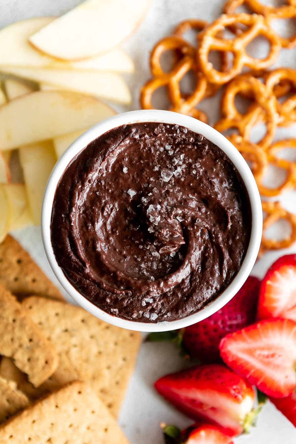 chocolate brownie batter hummus with pretzels and apples on the side