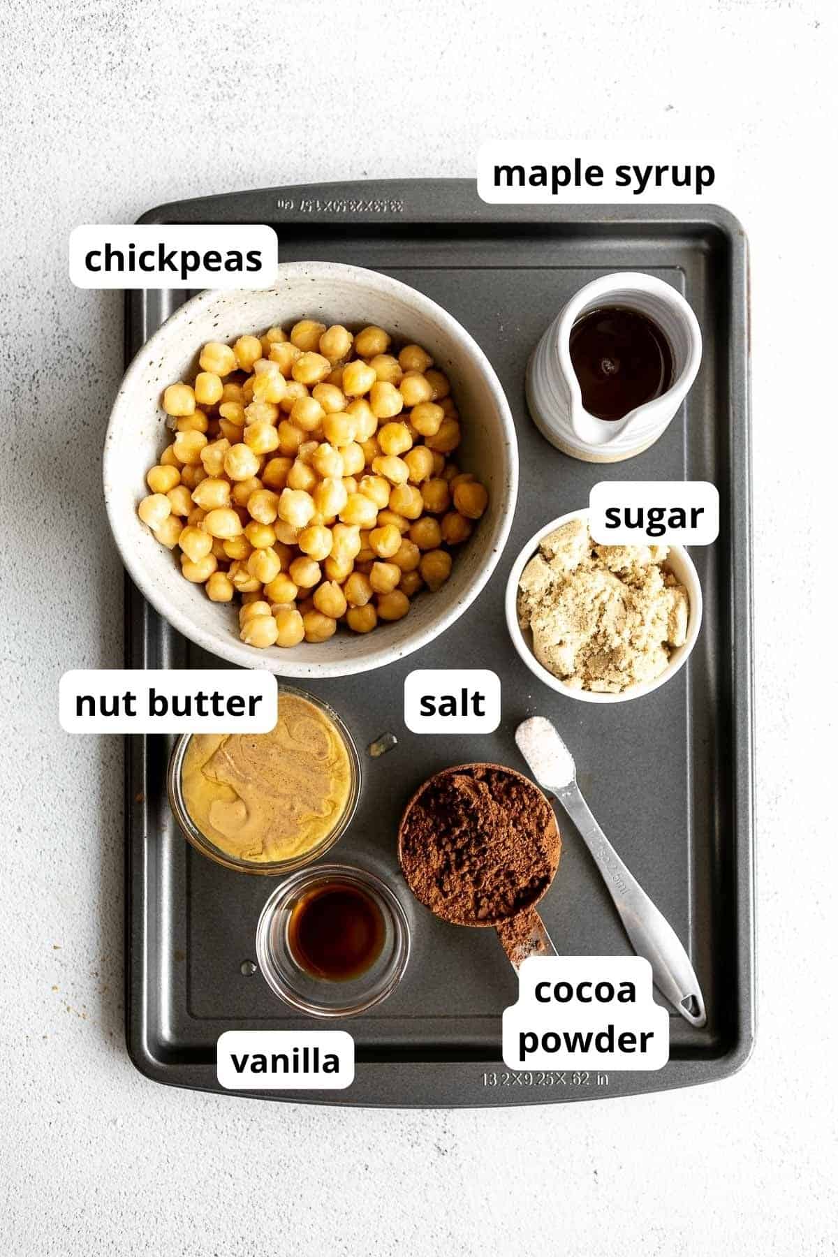 ingredients for the brownie hummus in bowls with labels