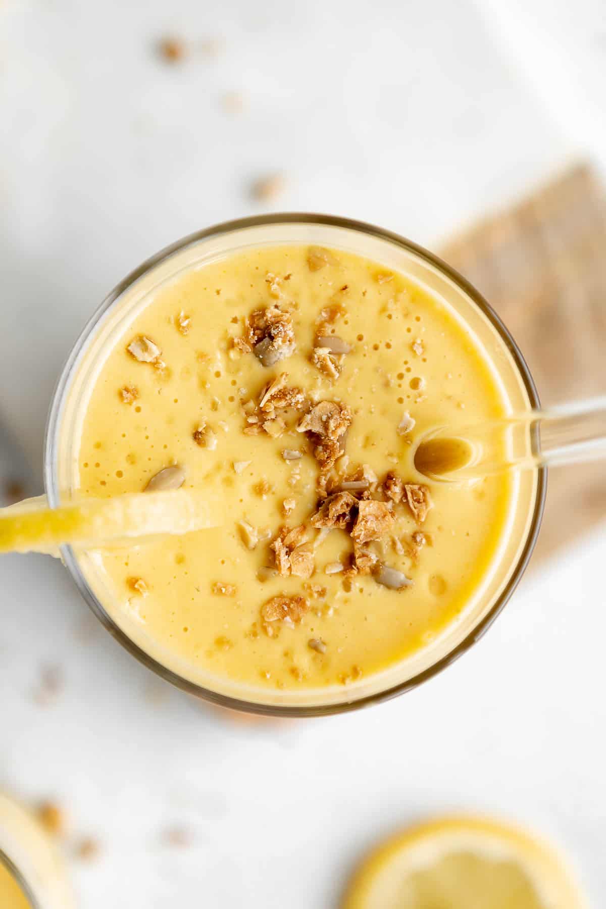 overhead shot of the smoothie with granola on top with lemon