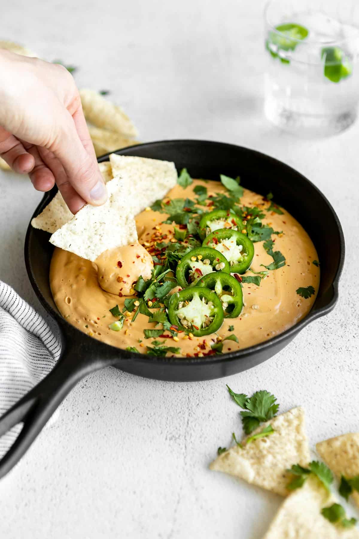 Dipping in a chip in the vegan cashew queso.